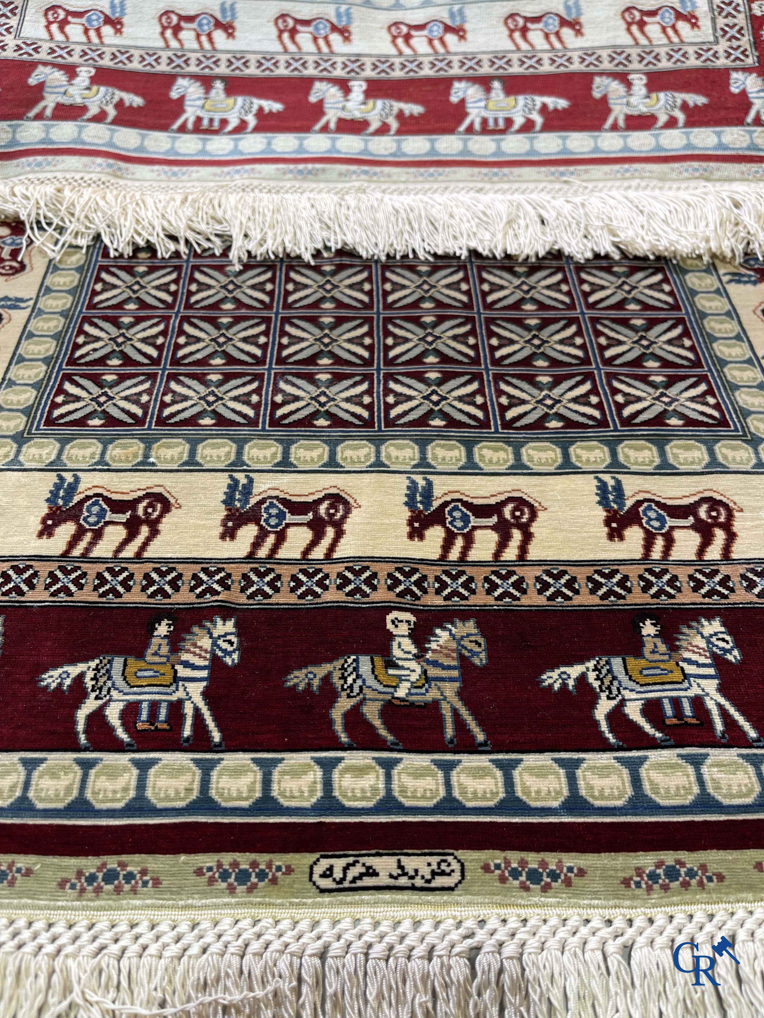 Oriental rugs: A small finely hand-knotted silk rug with deer and horsemen. Signed.