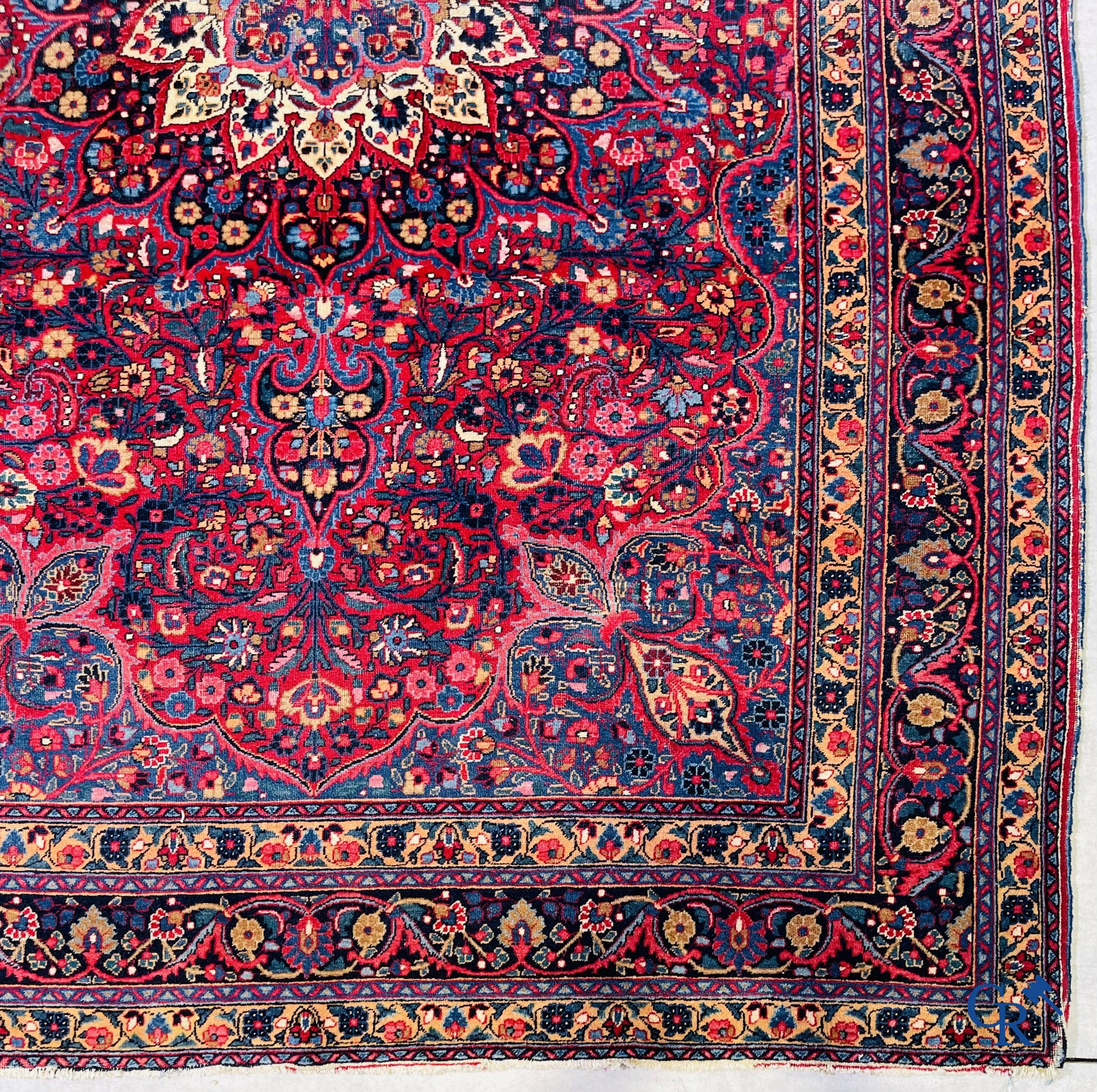 Oriental carpets: Iran, antique Persian carpet with dark red background.