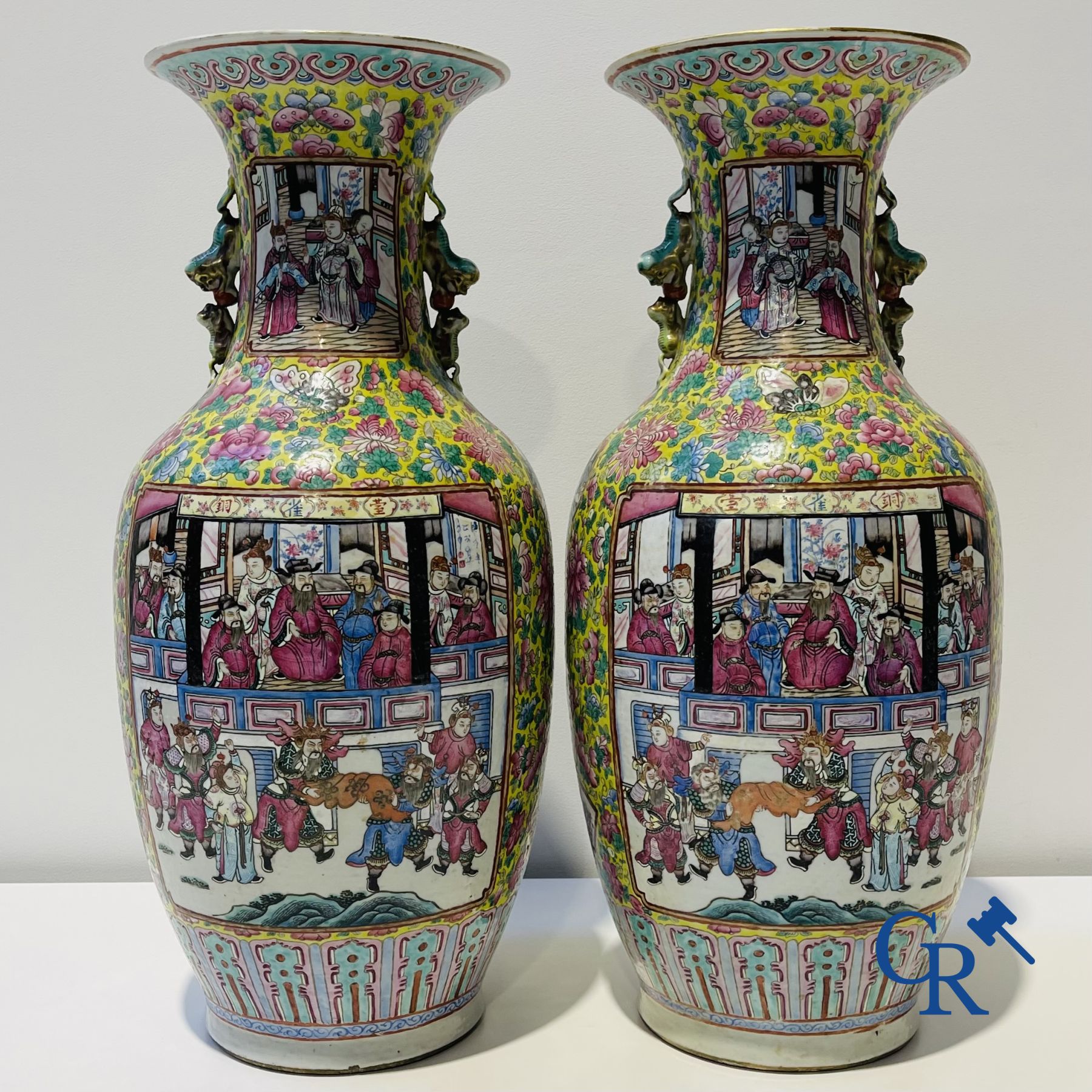 Asian art: A pair of Chinese famille rose vases with yellow background with court scenes. 19th century.