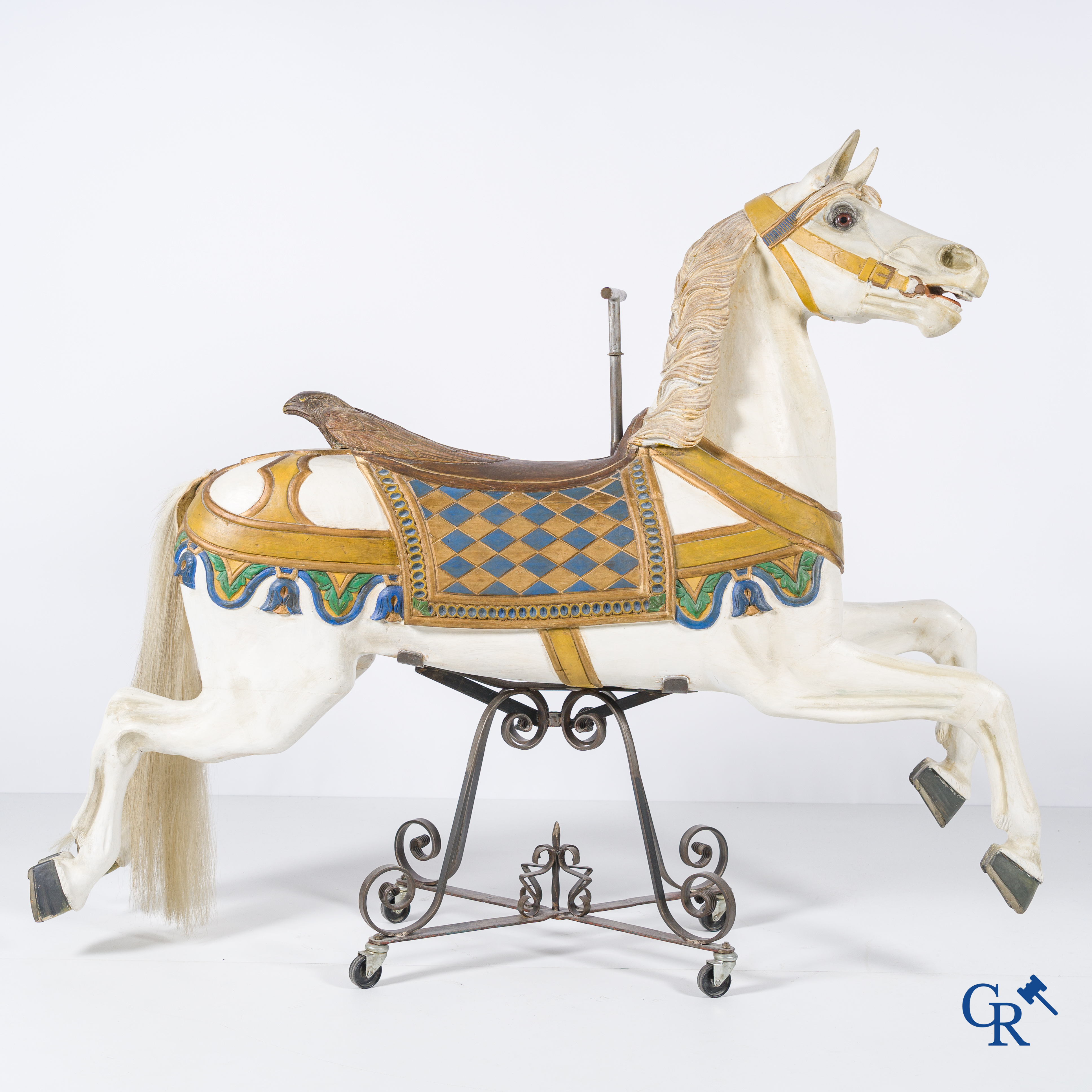 Kermis objecten, een houten carrousel paard met glazen ogen op een smeedijzer voet. Duitse makelij circa 1900 - 1920.