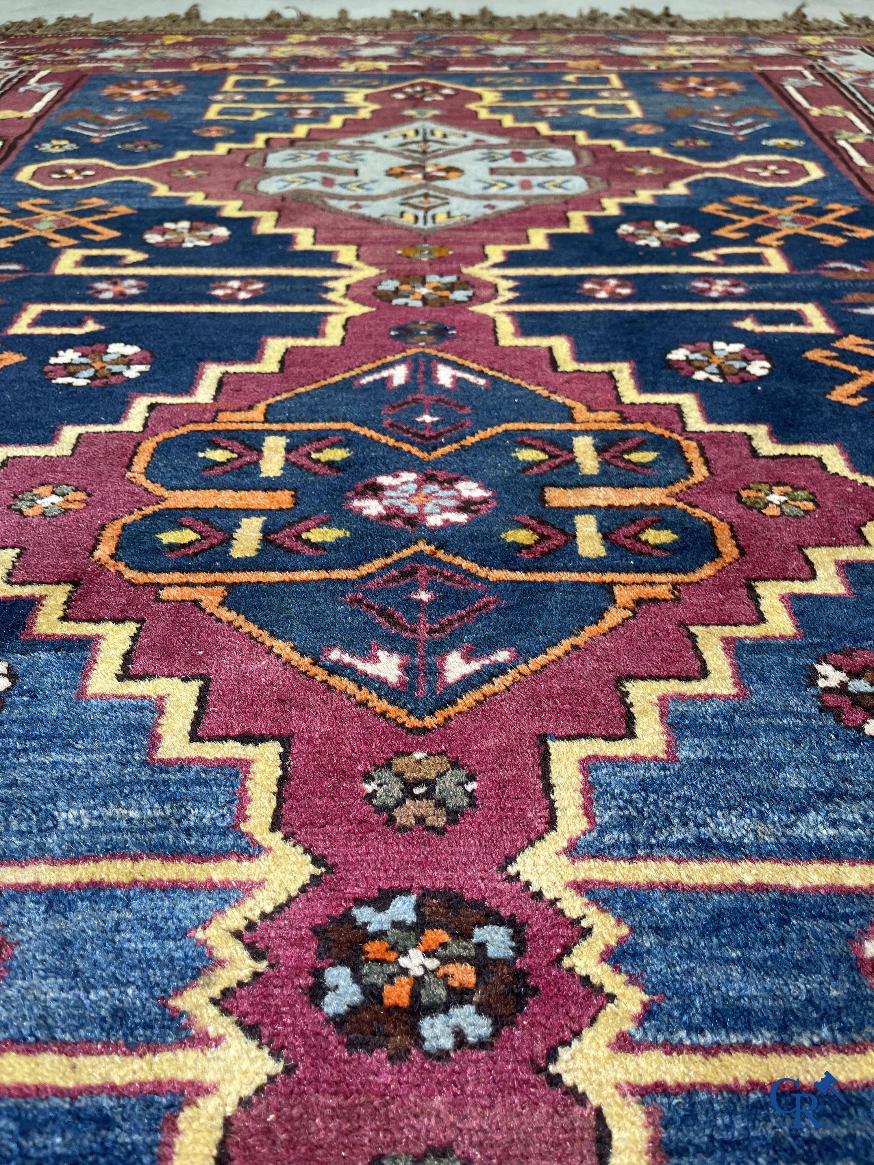 Oriental carpets, an antique hand-knotted Oriental carpet with motifs on a blue background.