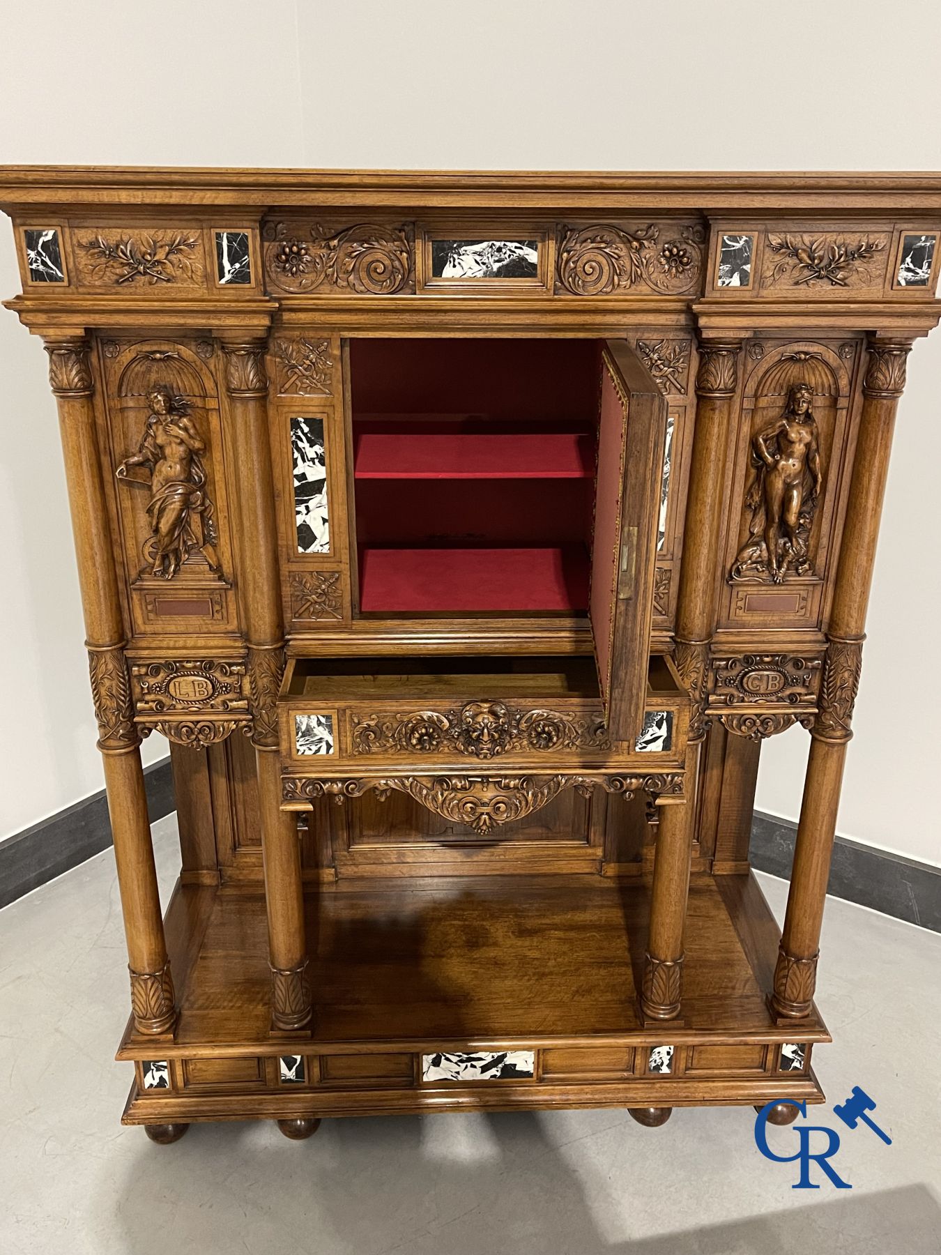 Furniture: A finely carved walnut credence in neo renaissance style with marble inlay.