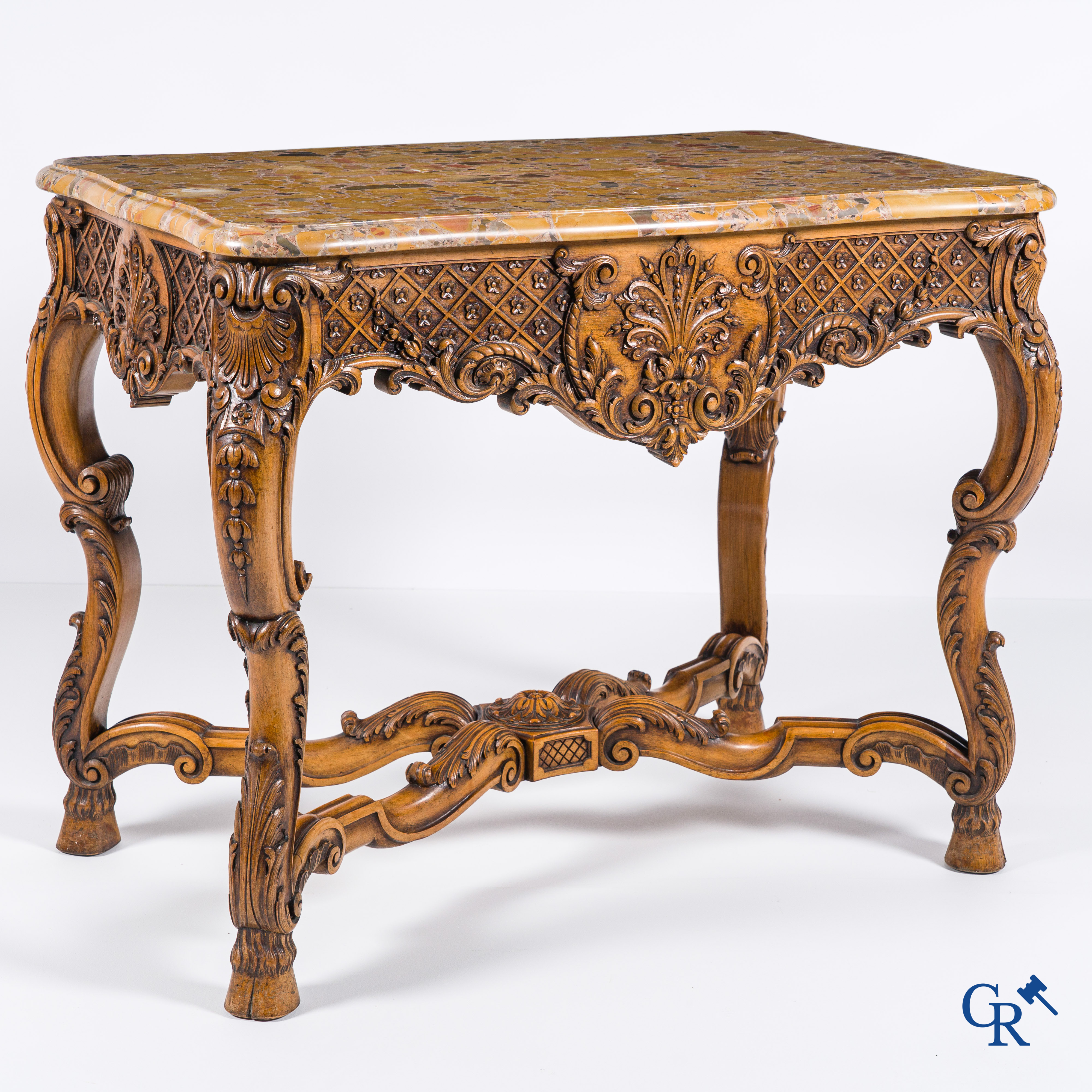 A richly carved wooden console table with a marble top. Circa 1930.