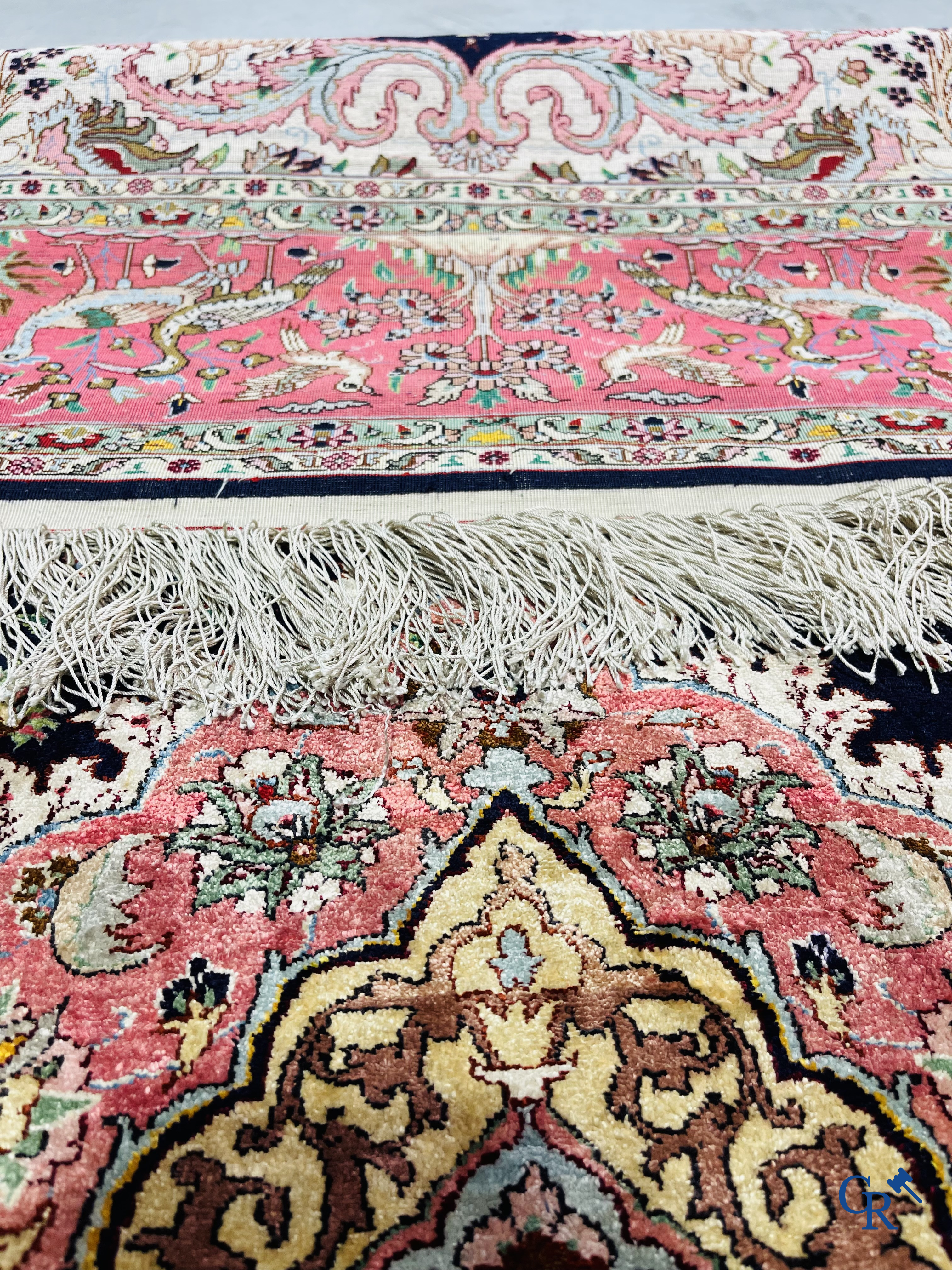 Oriental carpets: Tabriz, a finely hand-knotted silk carpet with forest animals and birds in a floral decor.