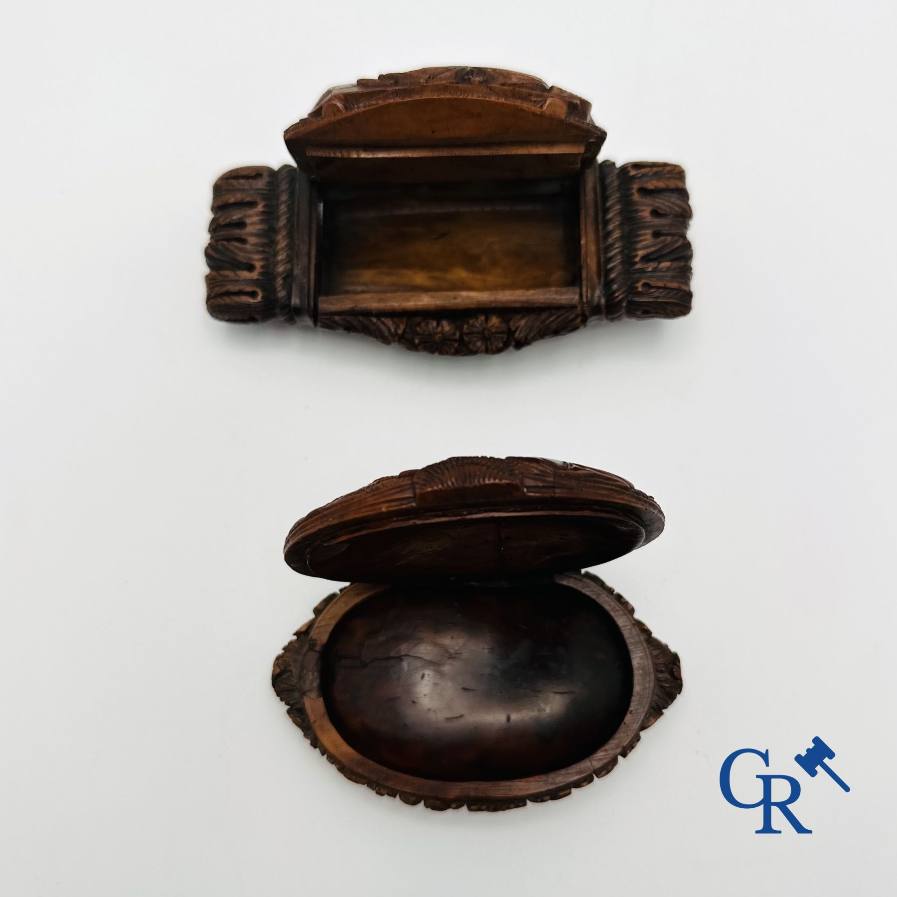 Display case objects: 2 pill boxes in sculpted corozo walnut.