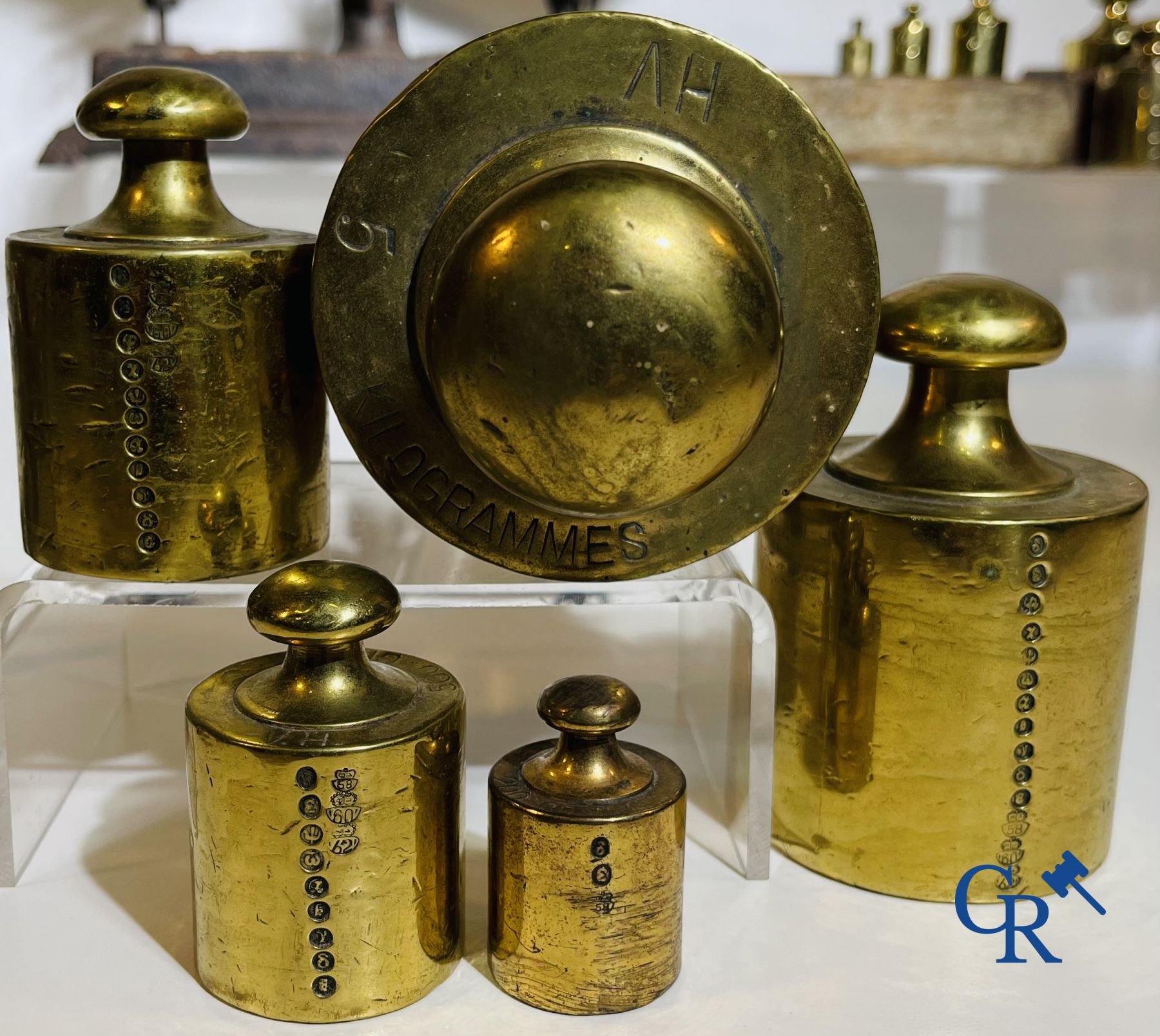 A various lot of antique calibration weights and a calibrated scale. 18th-19th century.