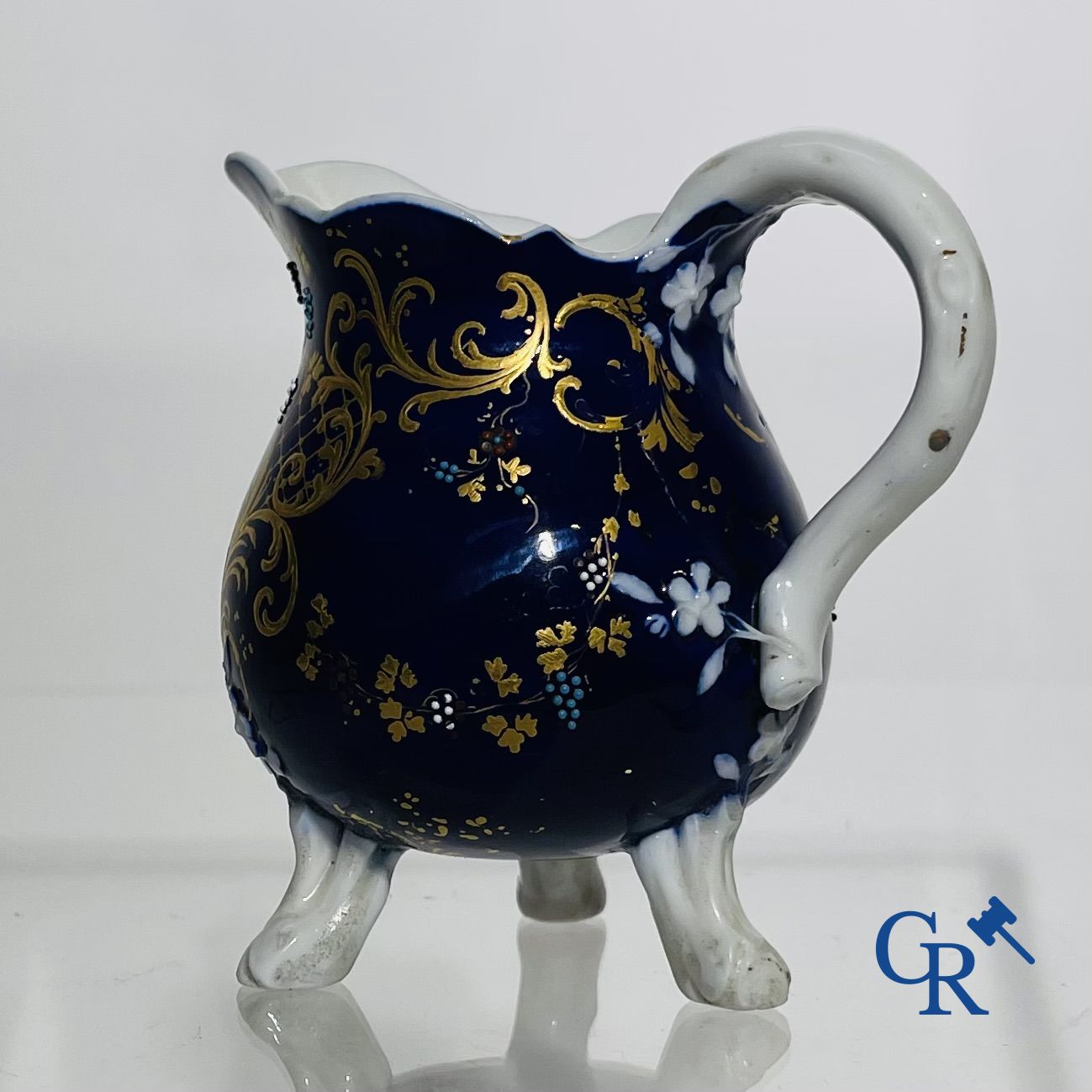 Vincennes 18th century. A three-legged milk jug in soft porcelain with lapis blue background.