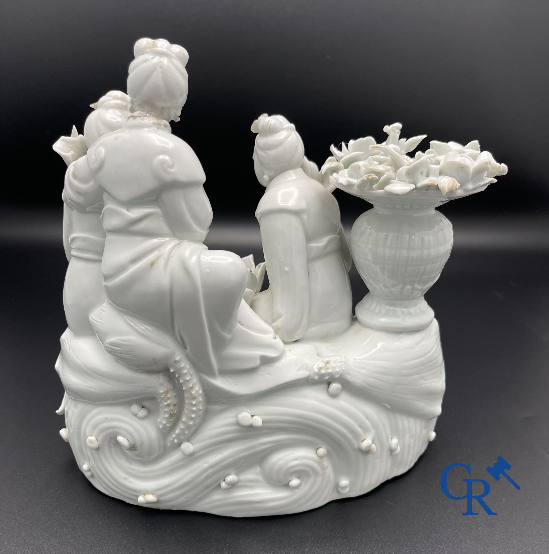 Chinese porcelain: A Buddhist lion and a group in blanc de Chine.