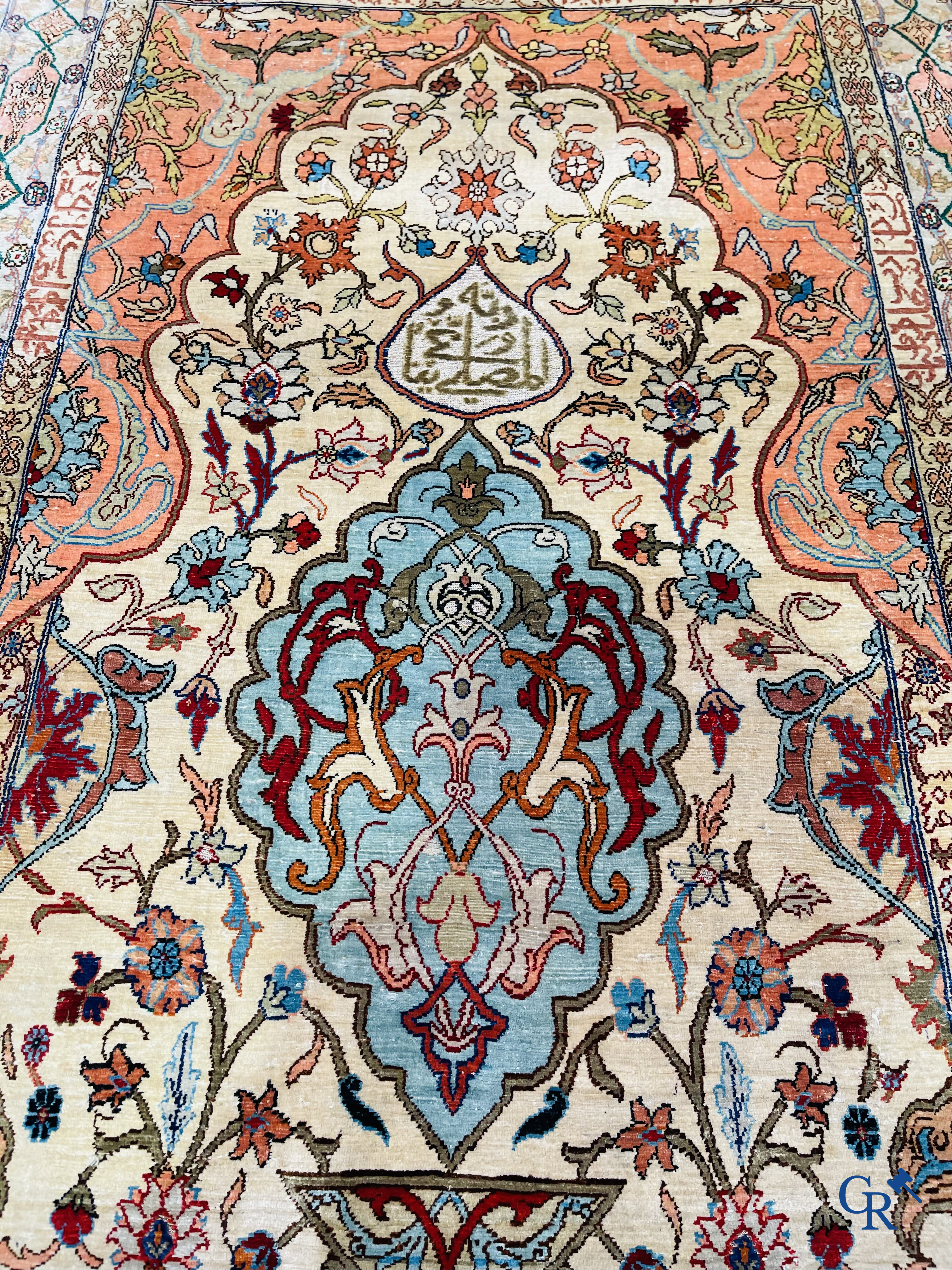 Oriental carpets, Hereke Turkey, a finely hand-knotted silk carpet with inscriptions and gold thread.