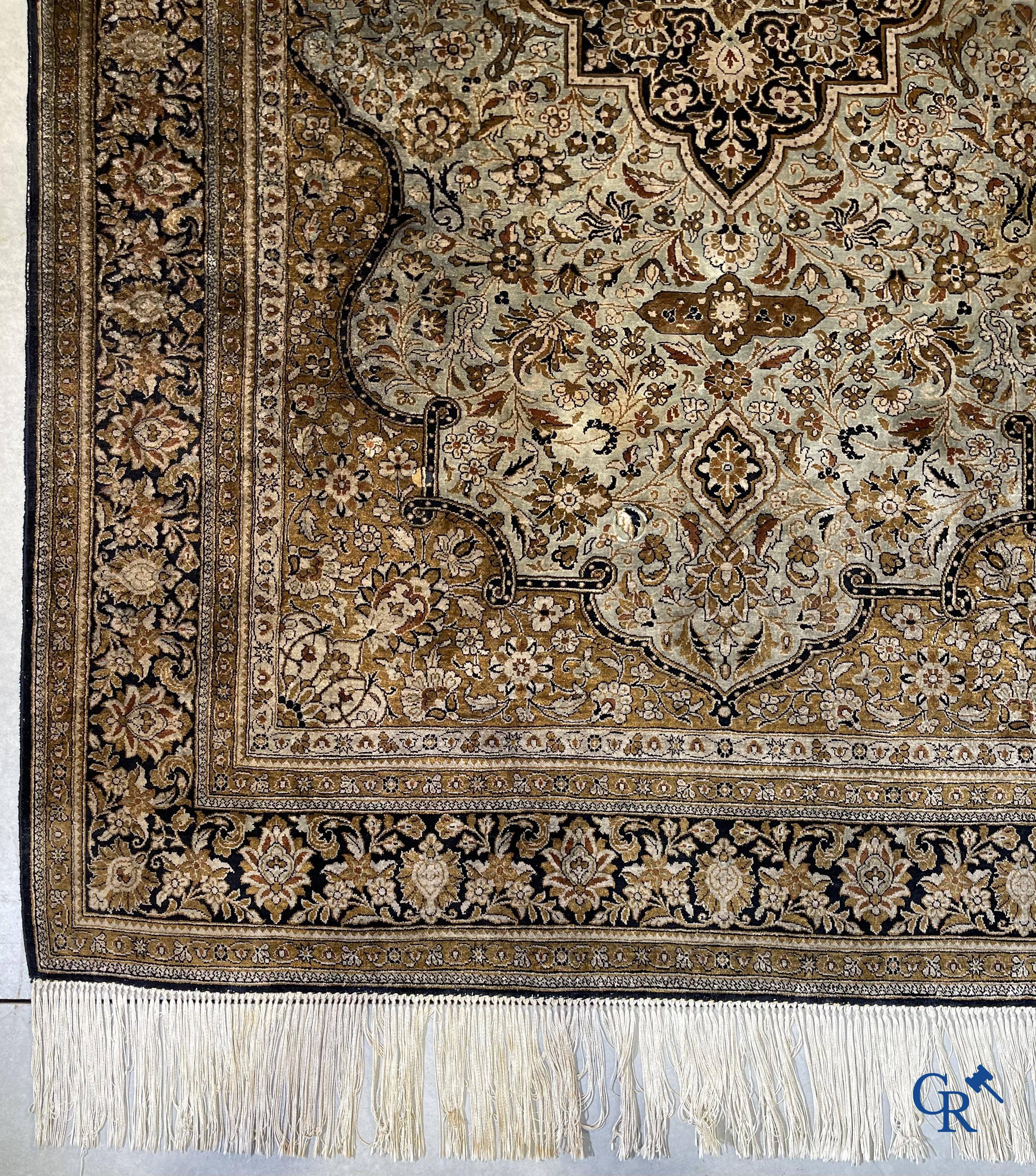 Oriental carpets. A finely hand-knotted silk Oriental carpet with floral decor.