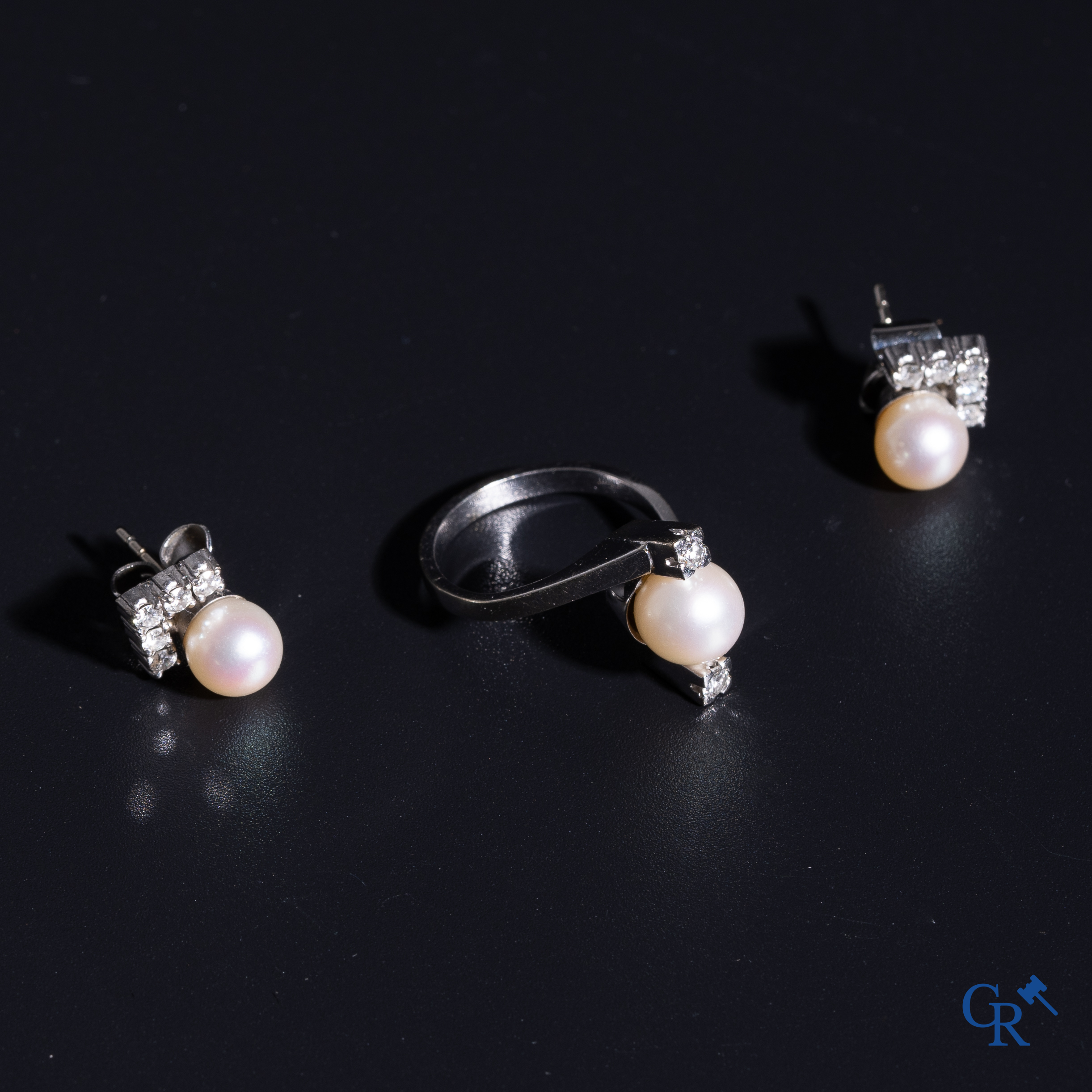 Jewellery: A ring and a pair of earrings in white gold 18K (750°/00) each set with a pearl and diamonds.