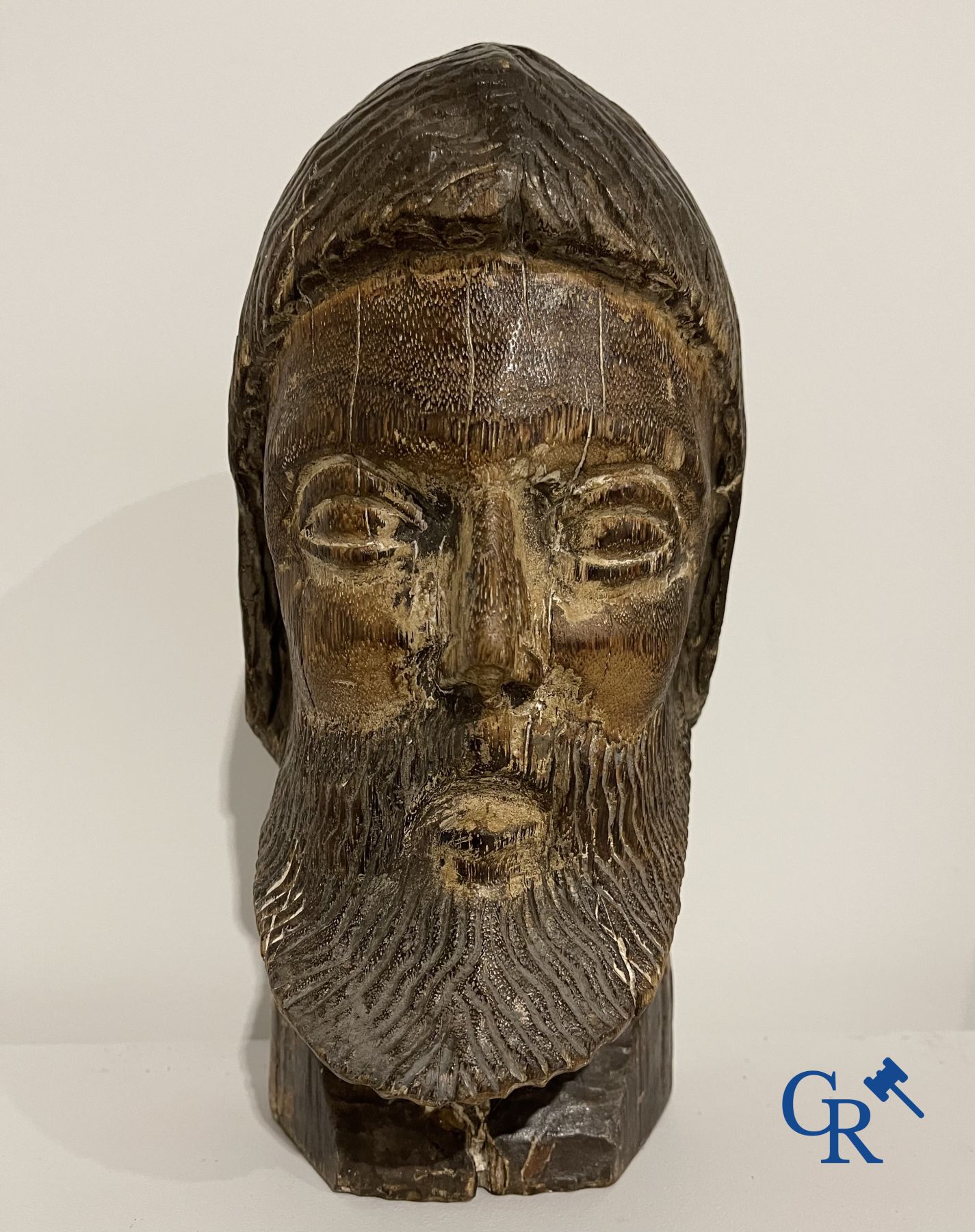 2 religious paintings and a wooden sculpted head of a saint.<br />
19th century.