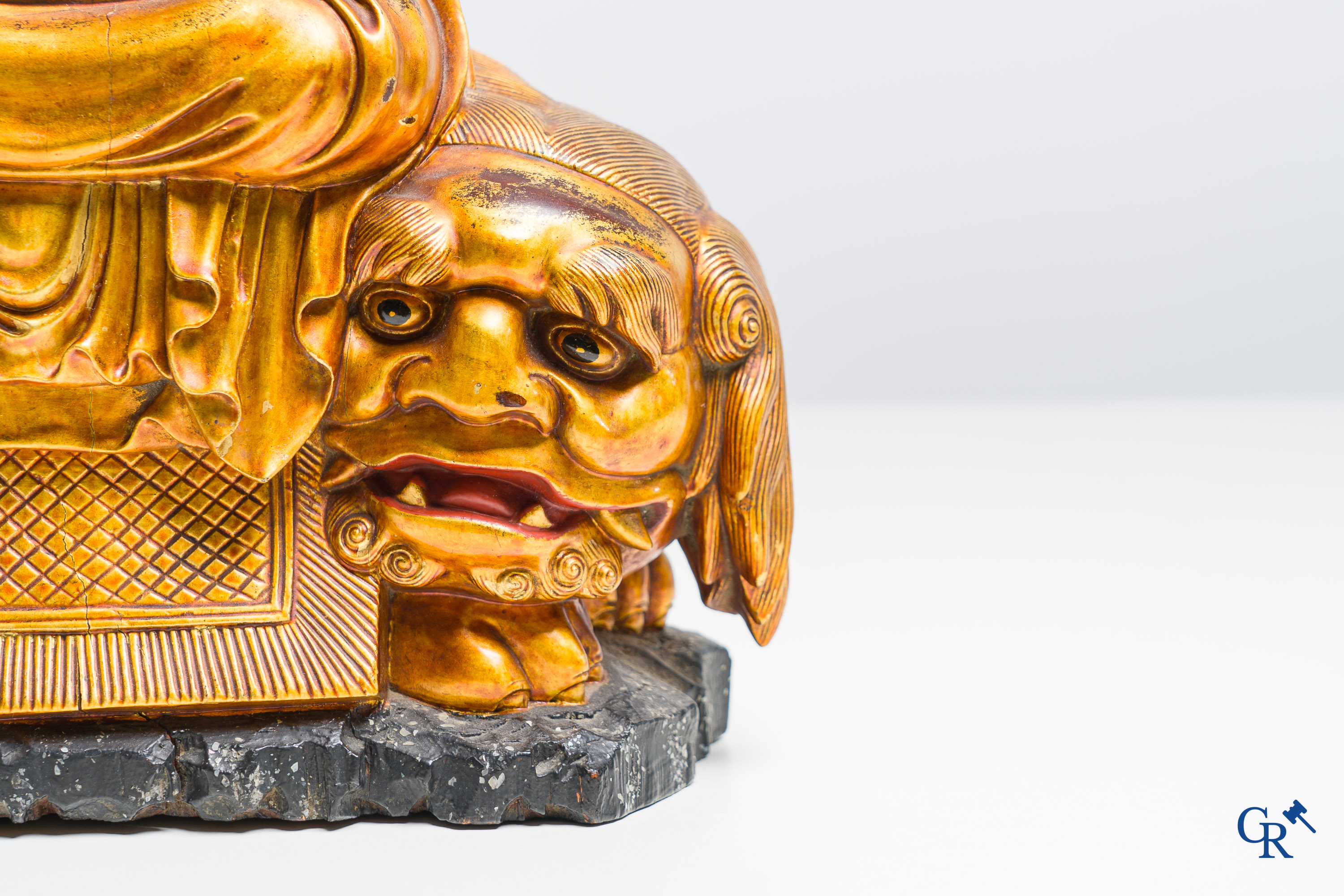 Asian Art: A Chinese sculpture of Vaishravana on a Buddhist lion in lacquered and gilded wood. 19th century.