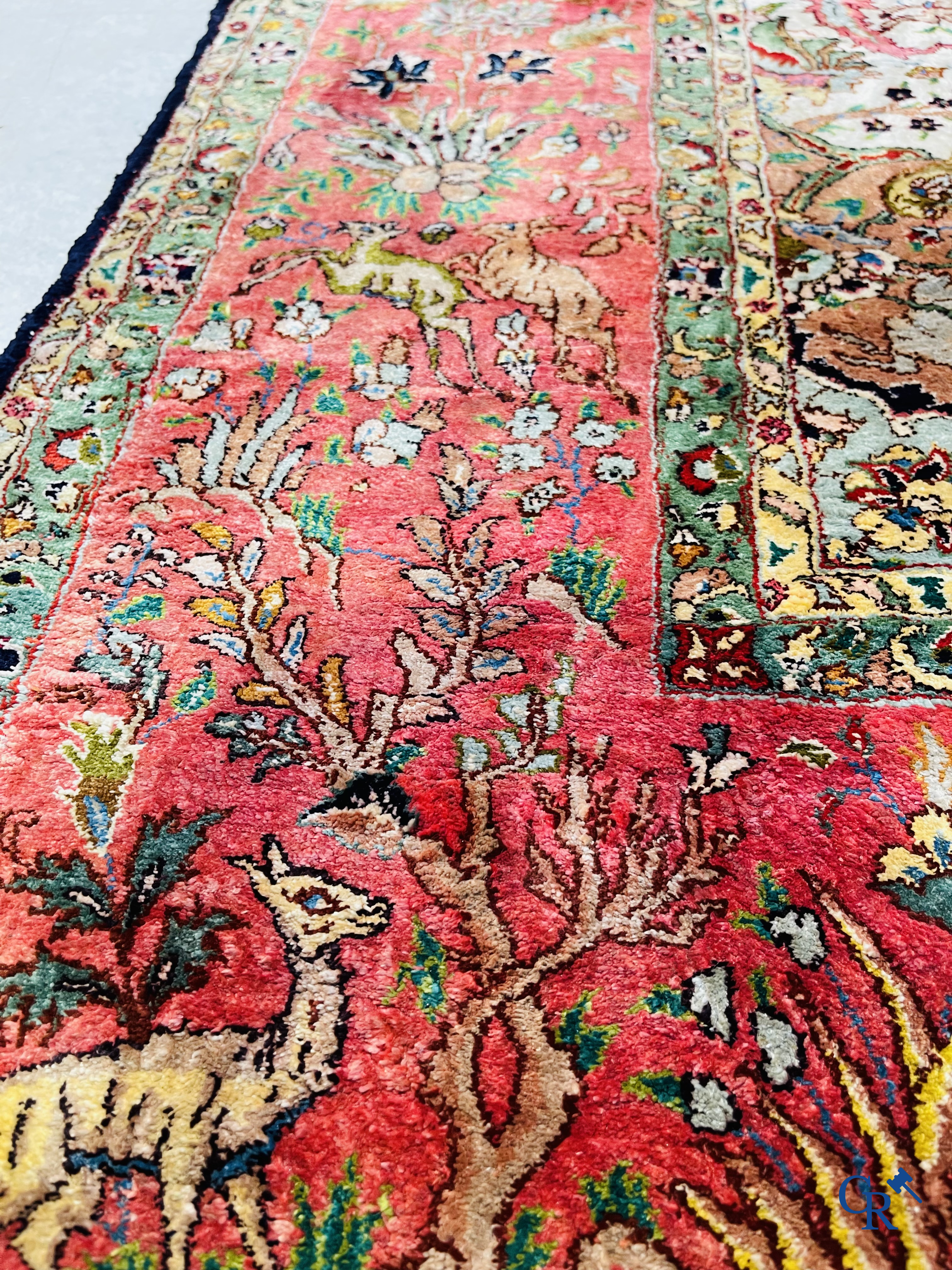 Oriental carpets: Tabriz, a finely hand-knotted silk carpet with forest animals and birds in a floral decor.