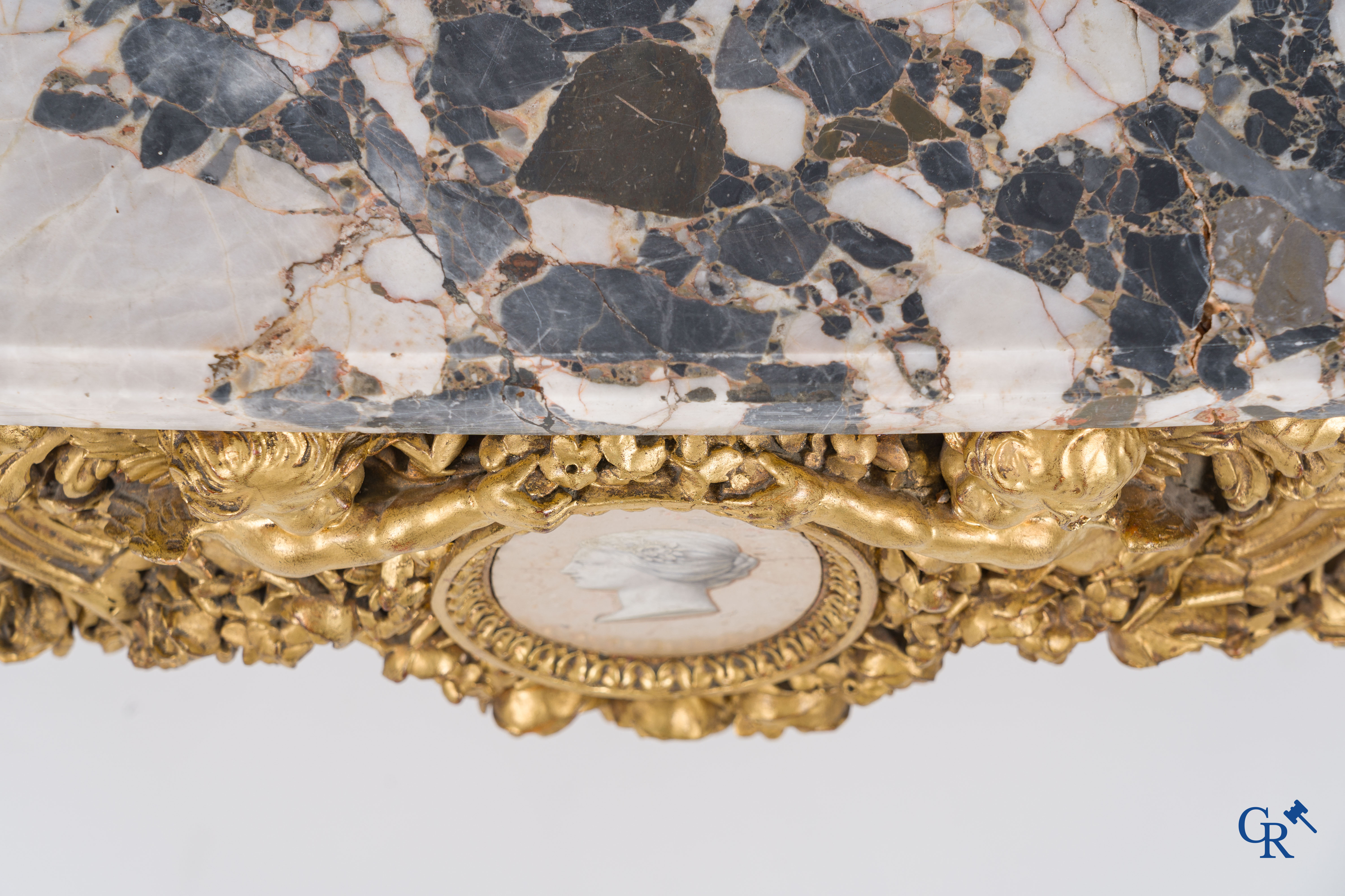 A richly carved and gilded console table in LVXI style with a grisaille painting on marble.