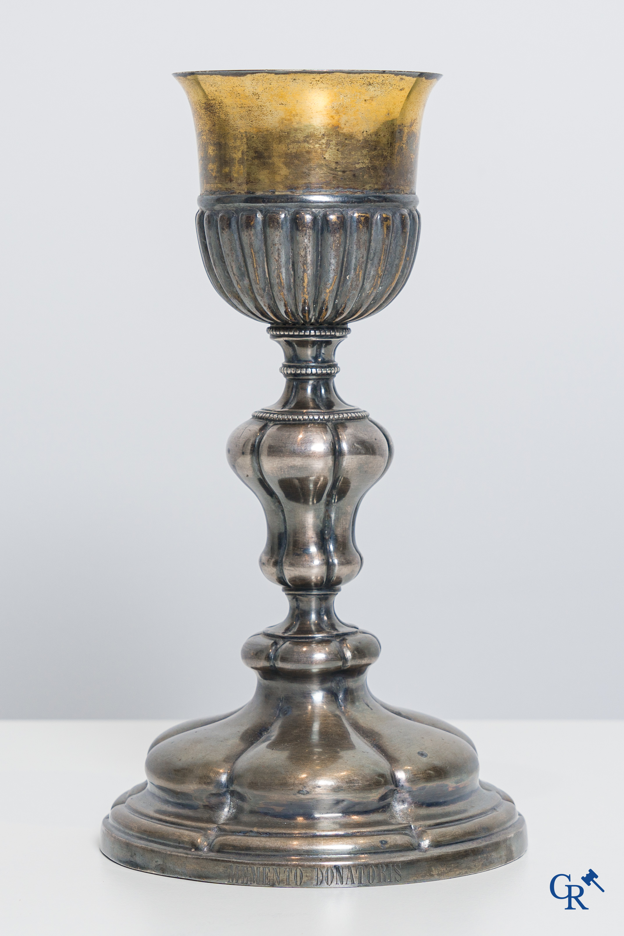 Religious objects. A silver- and gold plated chalice with Memento Donatoris inscriptions.