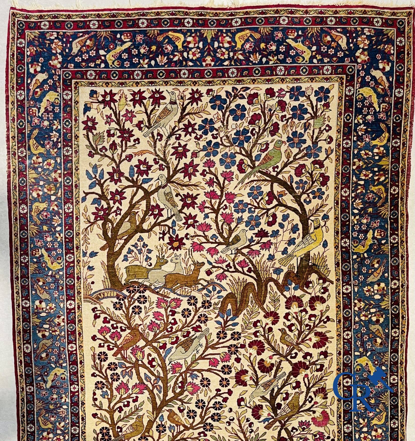 Oriental carpets: Antique oriental carpet with a decor of animals and birds in the forest.