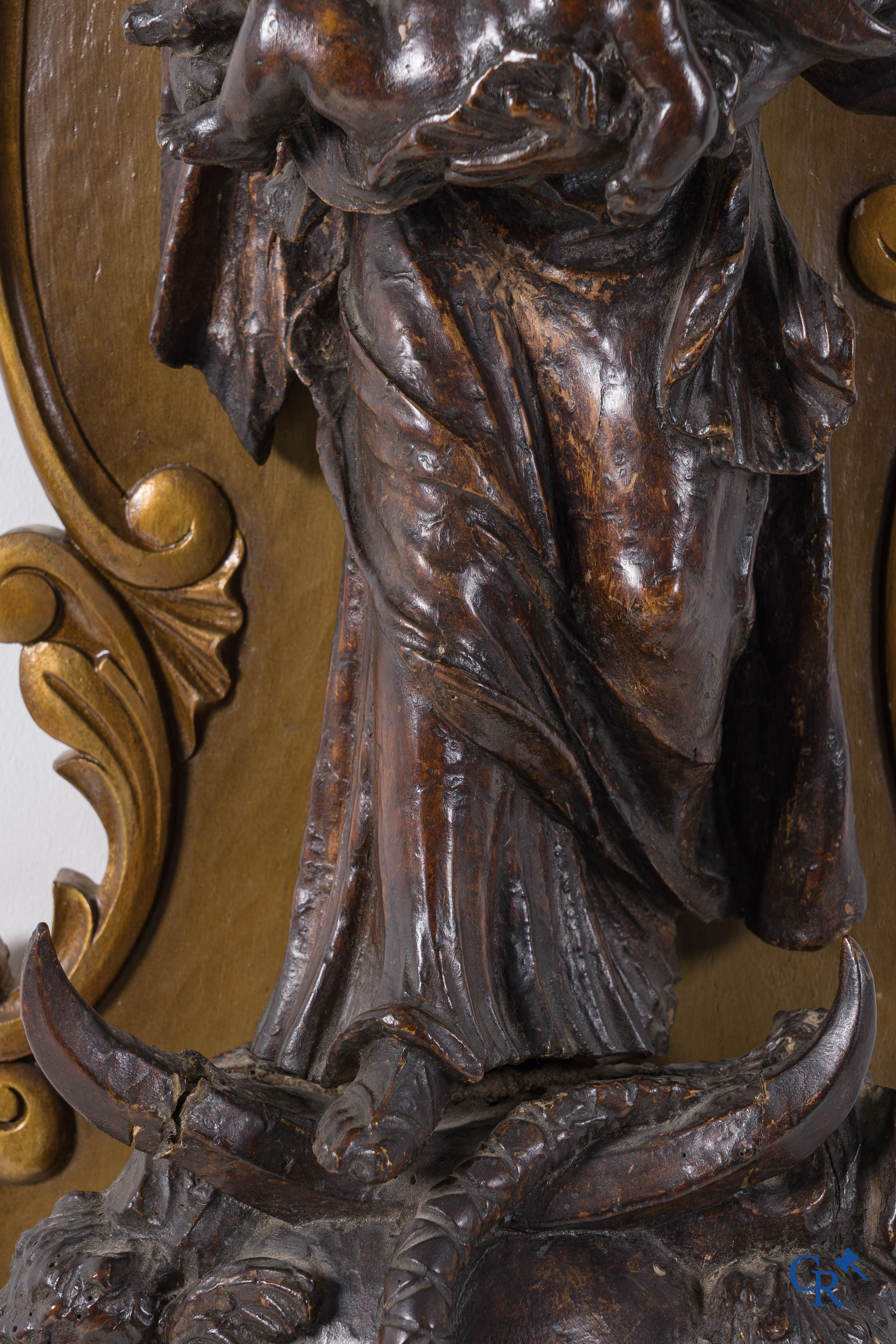 Imposing wooden sculpture of Mary with child, richly sculpted with angels and a dragon. 17th-18th century.