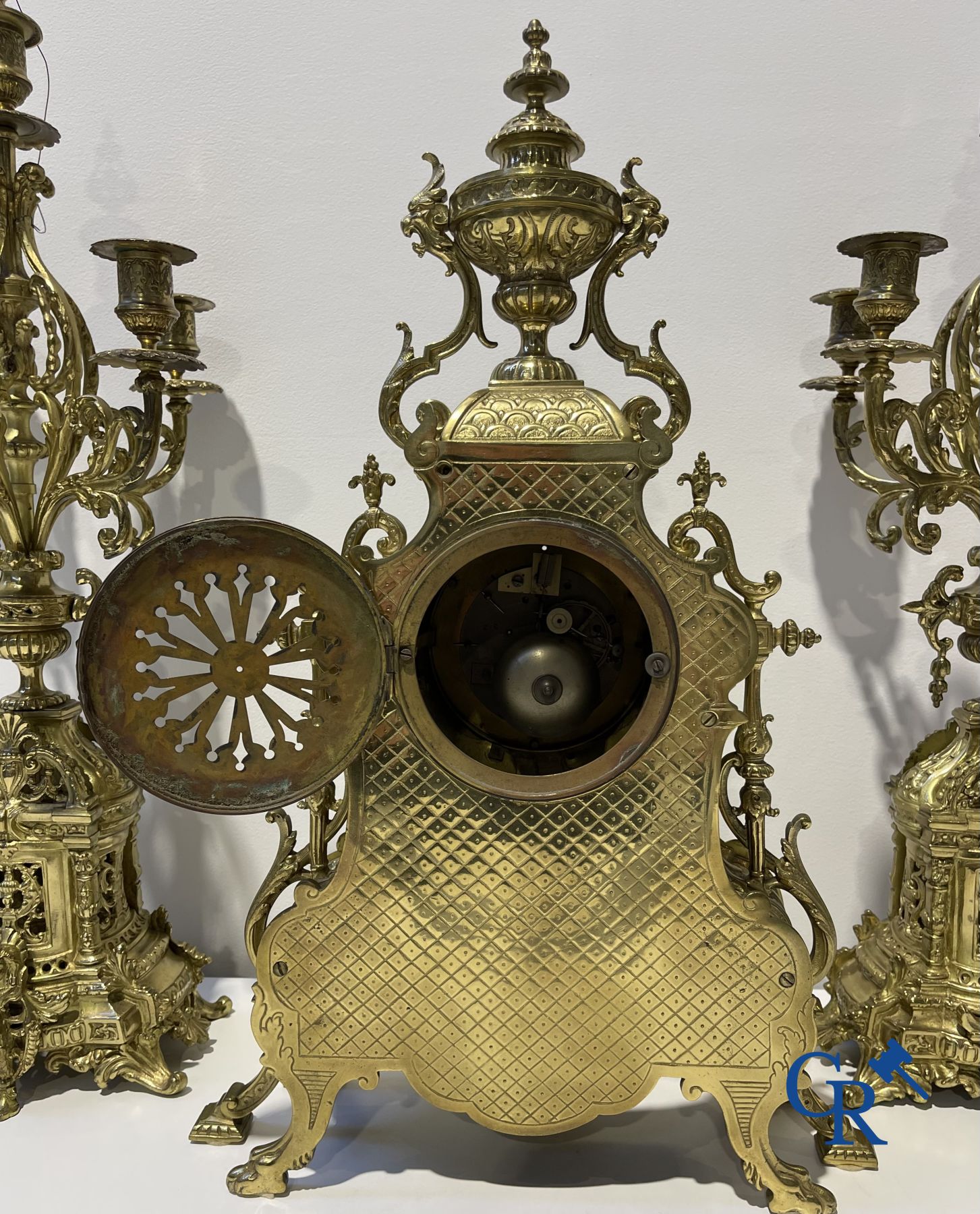 A three-part bronze fireplace clockset in Renaissance style and 2 painted tin and bronze pendant clocks.