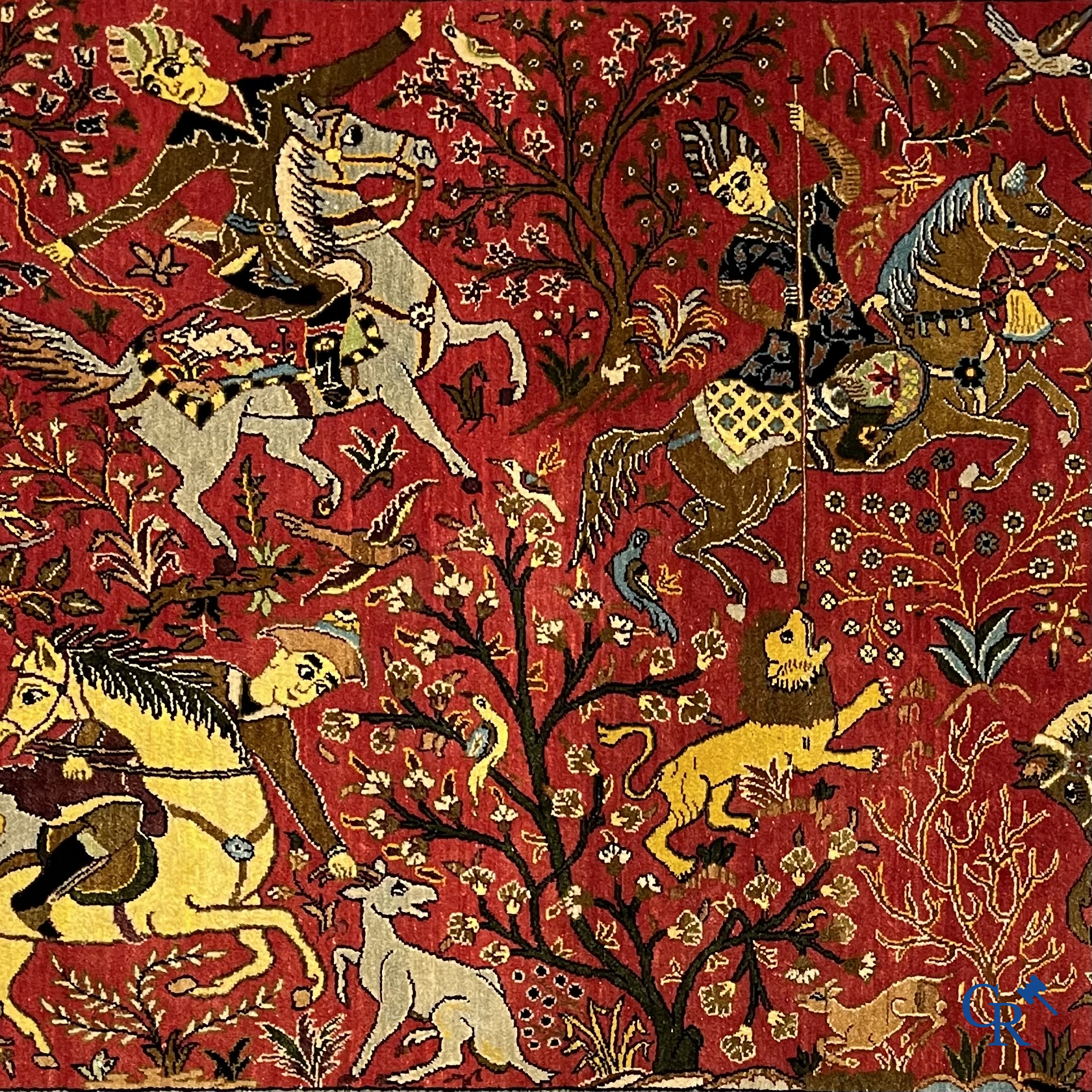 Oriental carpets, a Persian carpet in silk with a scene of hunters on horseback.