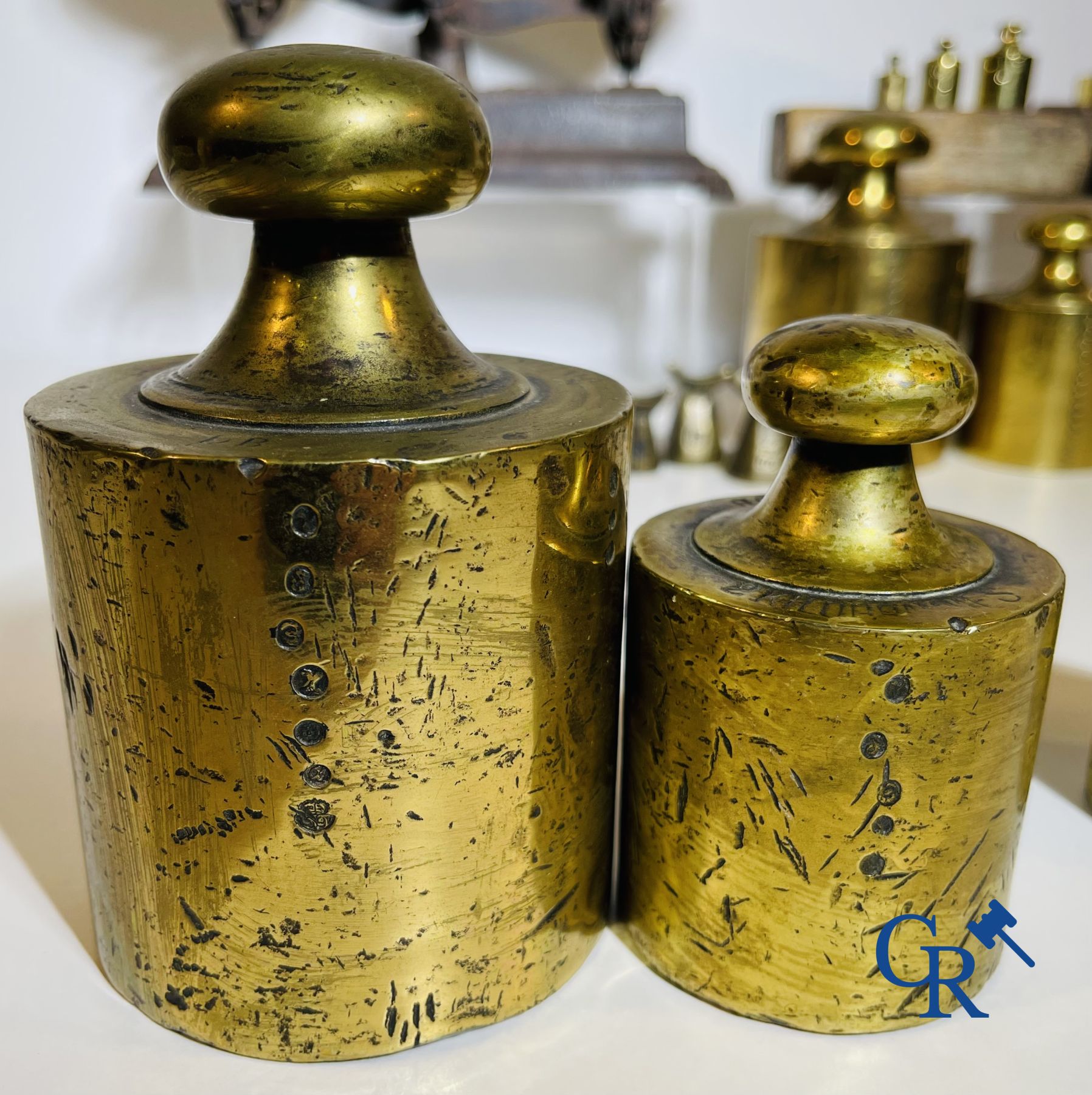 A various lot of antique calibration weights and a calibrated scale. 18th-19th century.