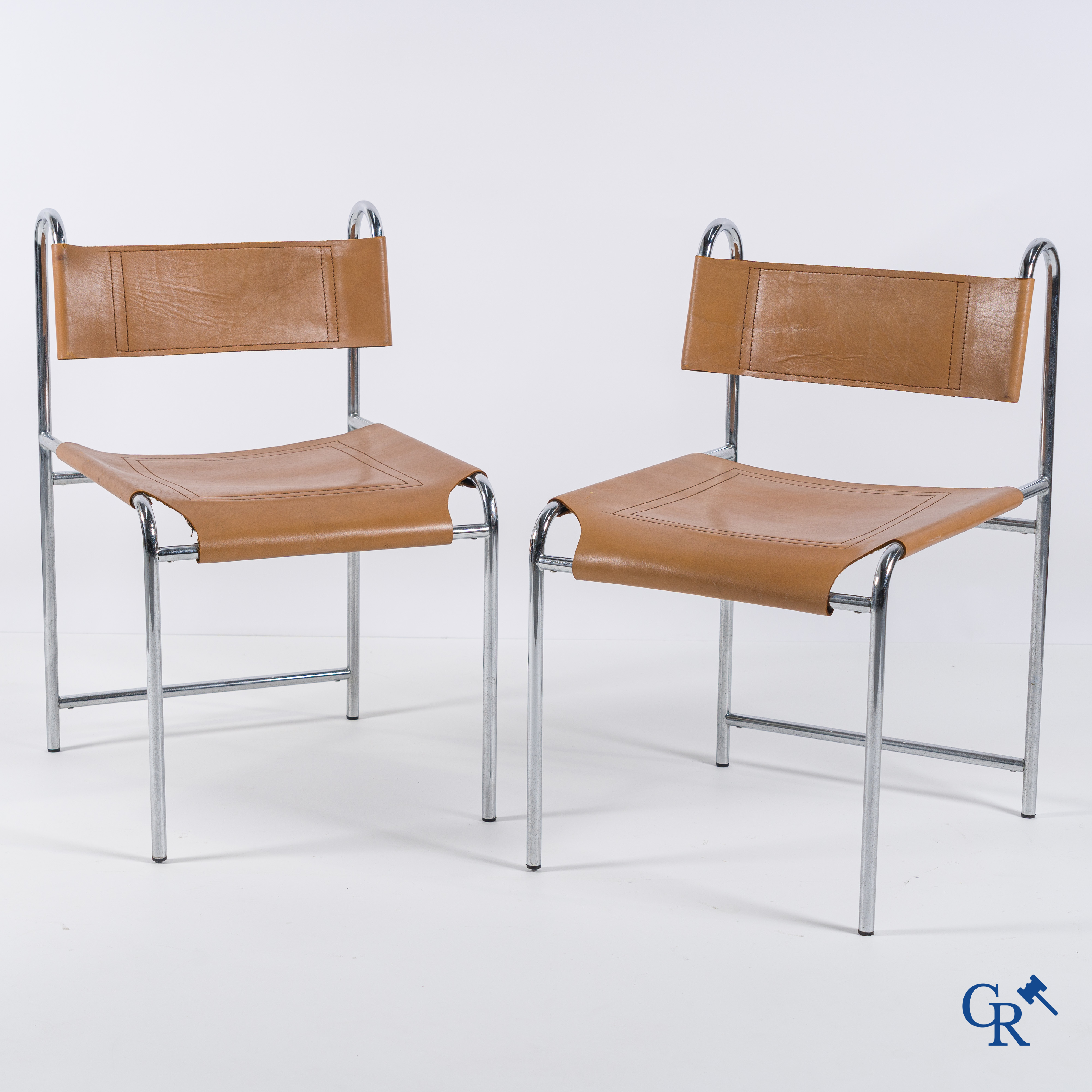 Design, 2 design chairs in chrome-plated metal and leather. Circa 1970.