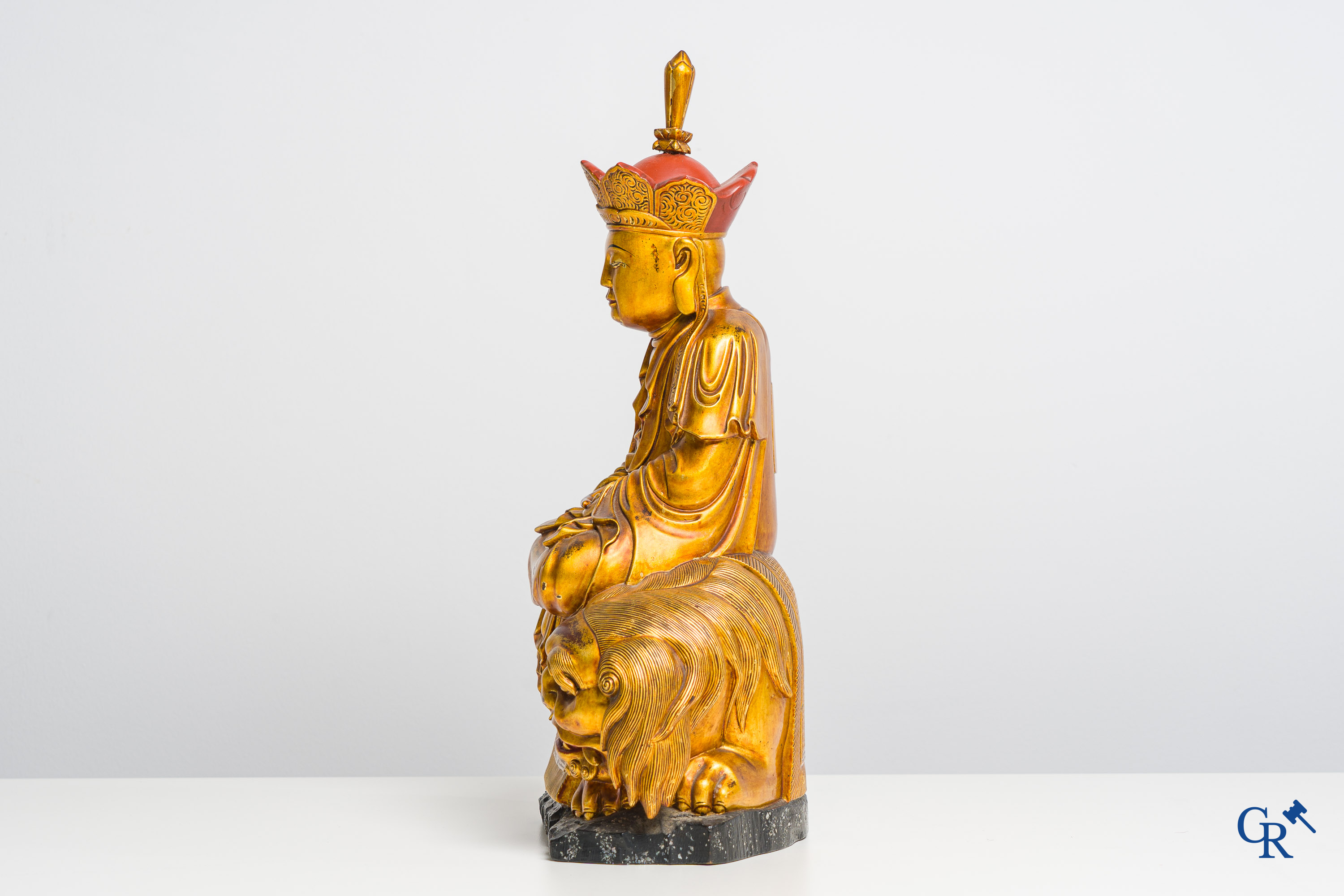 Asian Art: A Chinese sculpture of Vaishravana on a Buddhist lion in lacquered and gilded wood. 19th century.