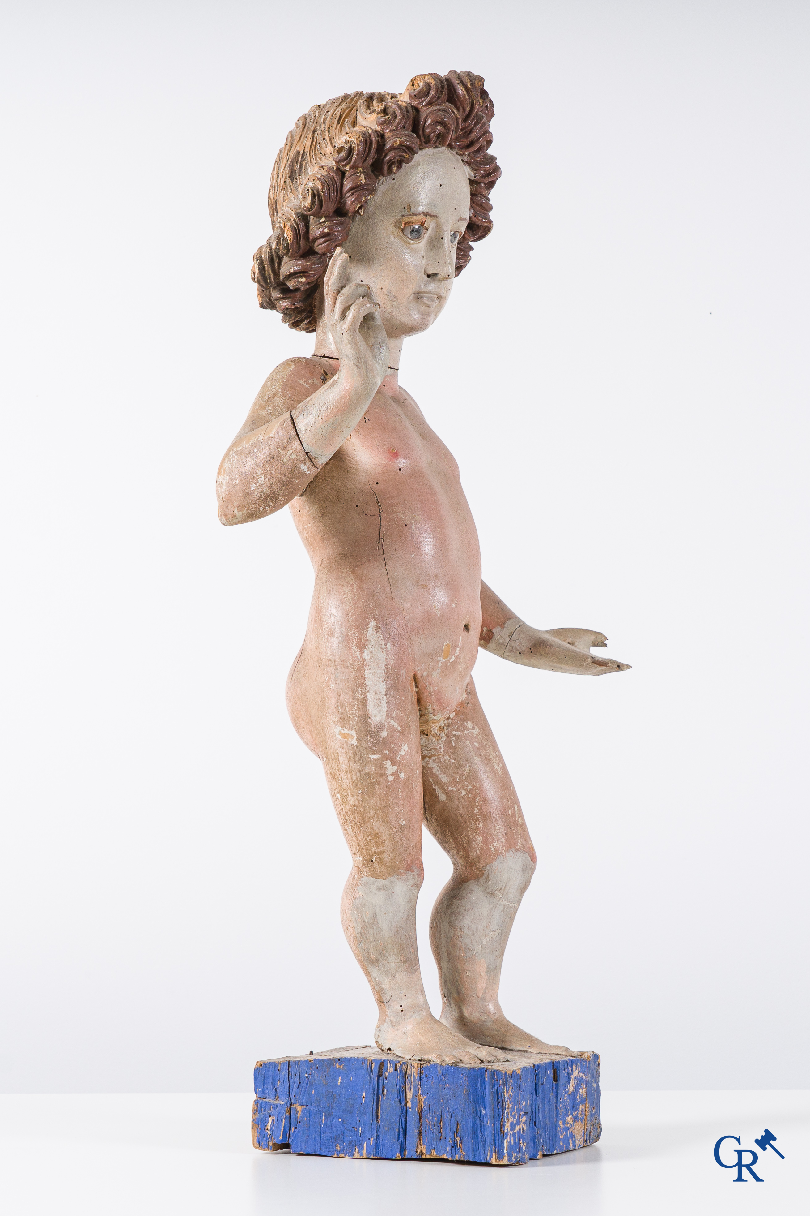 Religious objects. A polychrome wood sculpture depicting the child Jesus in Salvator Mundi. 17th-18th century.