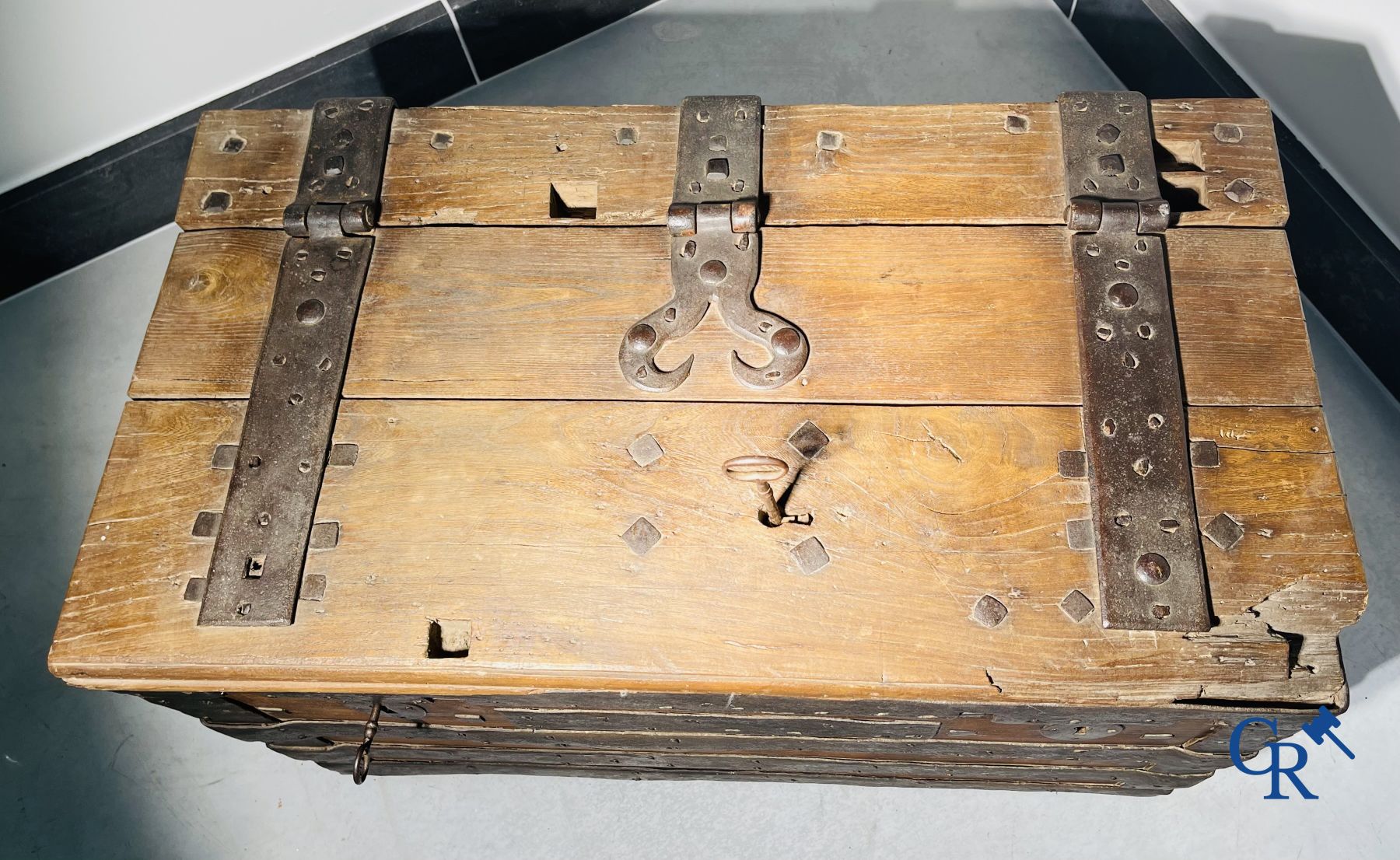 Antique wooden chest with hardware and lockwork in forging.