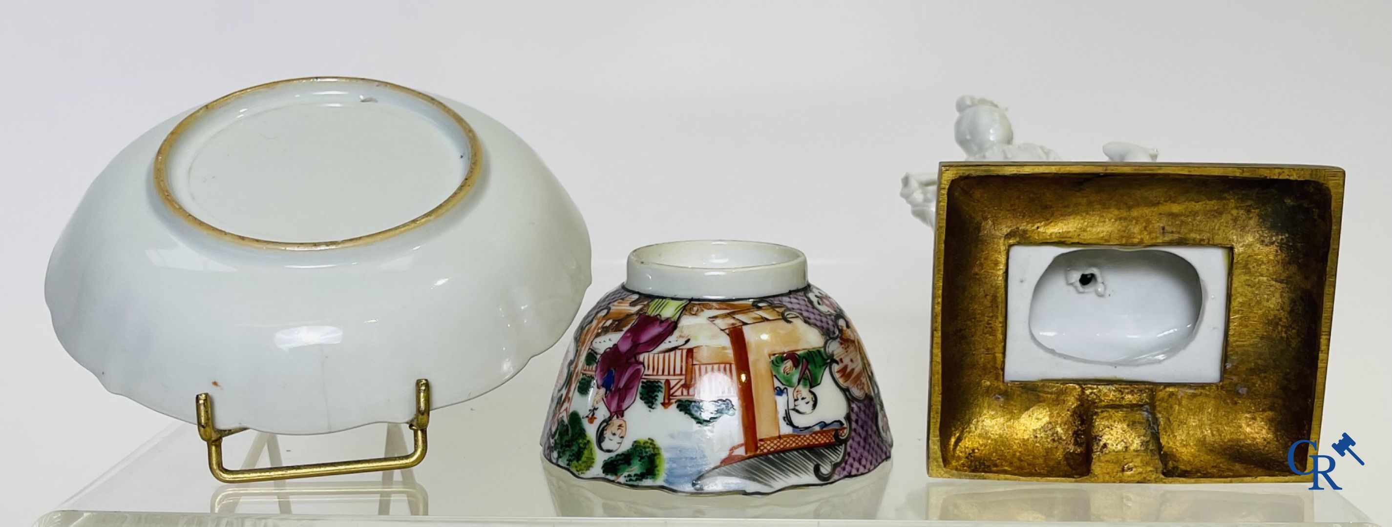 A large Chinese famille rose mandarin bowl, a famille rose cup and saucer and a figurine in blanc de chine.