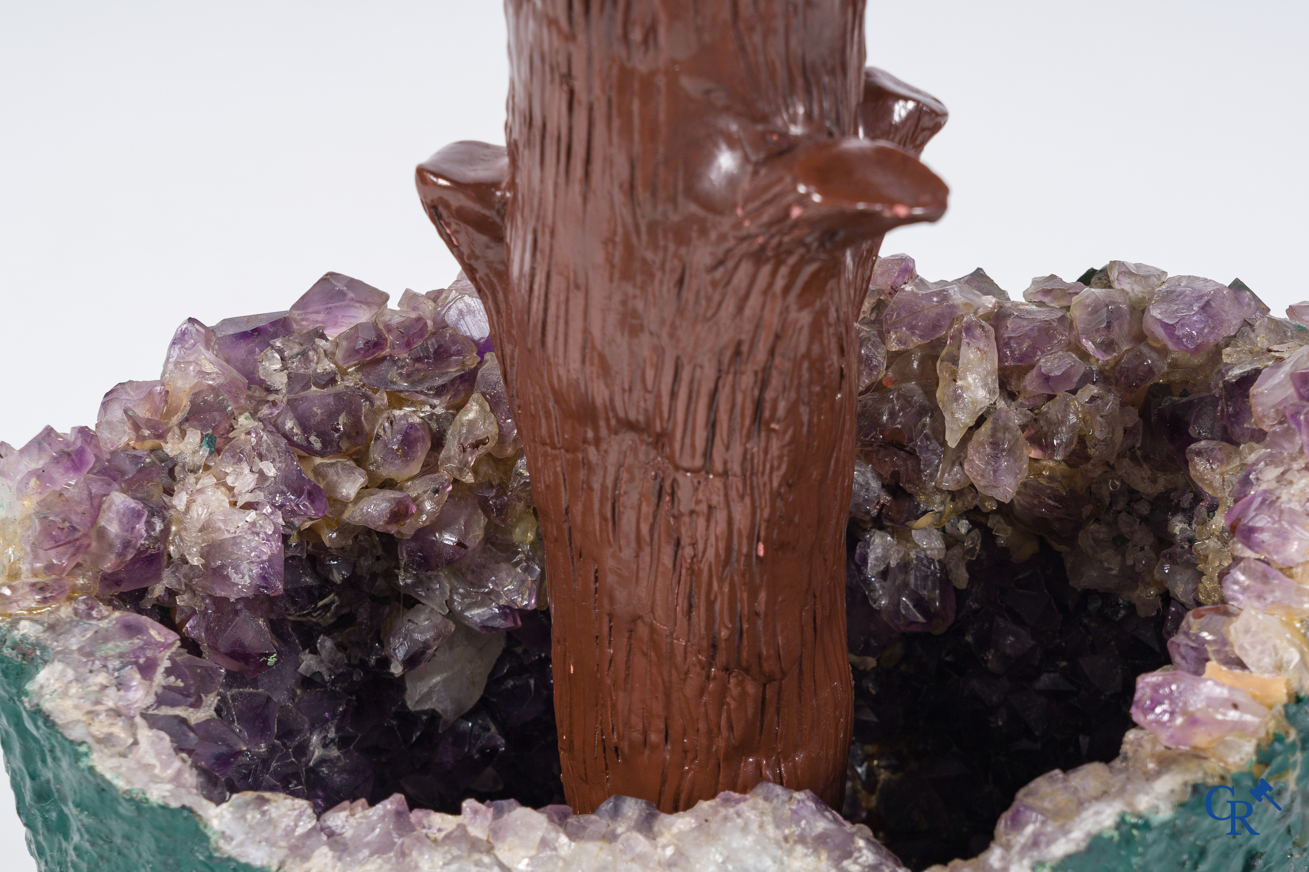 A decorative amethyst vase with a tree in various rocks. Circa 1960-1970.