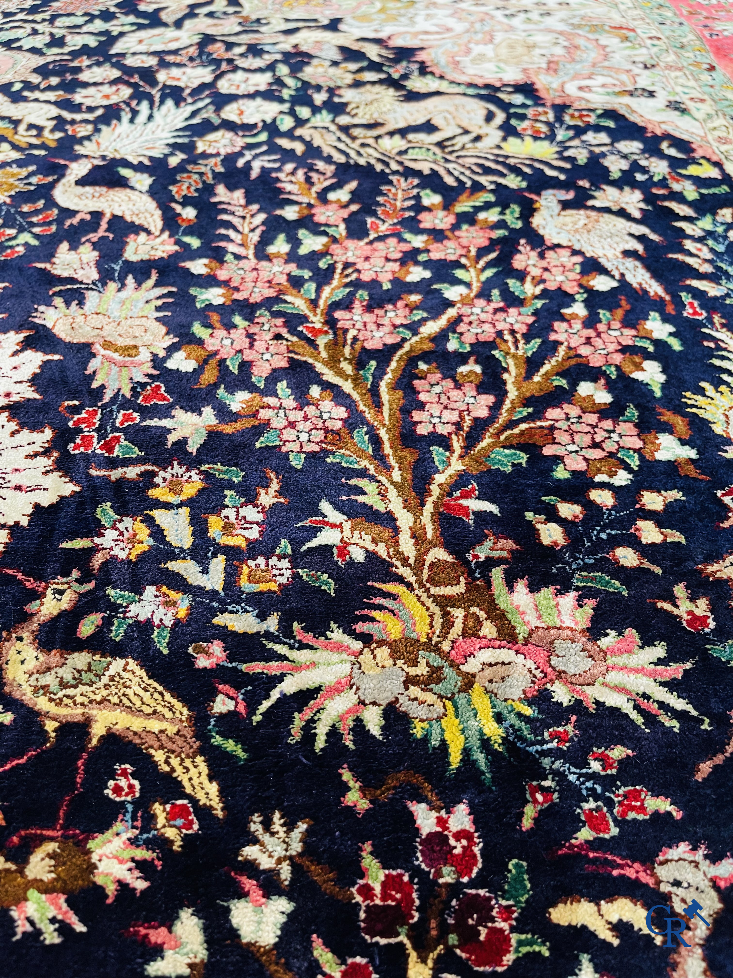 Oriental carpets: Tabriz, a finely hand-knotted silk carpet with forest animals and birds in a floral decor.