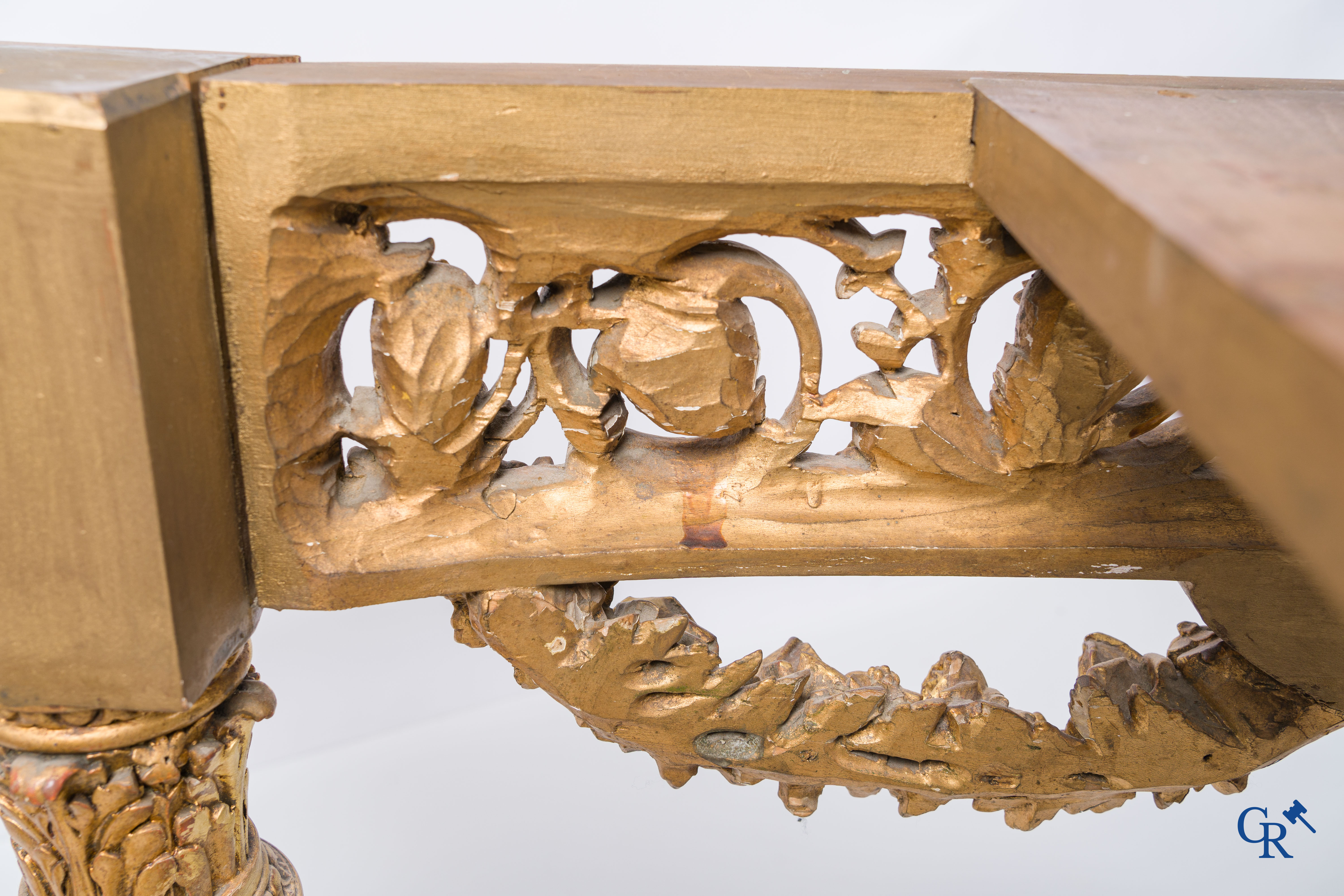 A richly carved and gilded console table in LVXI style with a grisaille painting on marble.