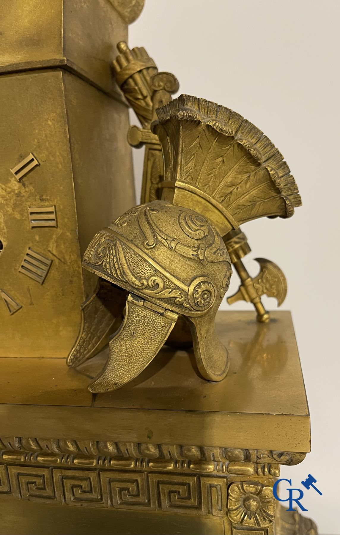 Imposing fire-gilded empire pendulum depicting a seated Roman emperor.