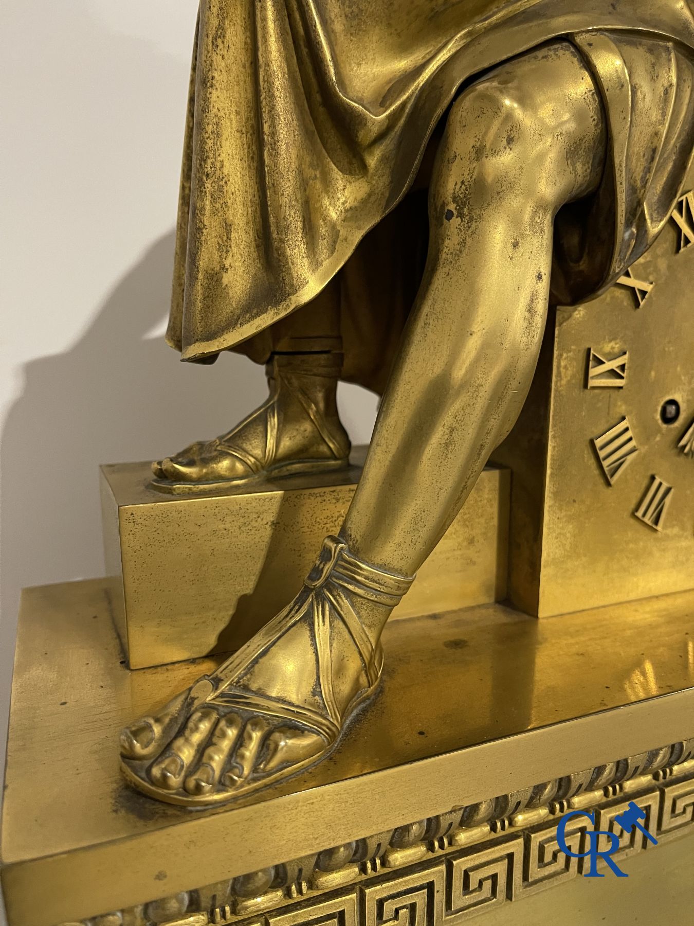 Imposing fire-gilded empire pendulum depicting a seated Roman emperor.