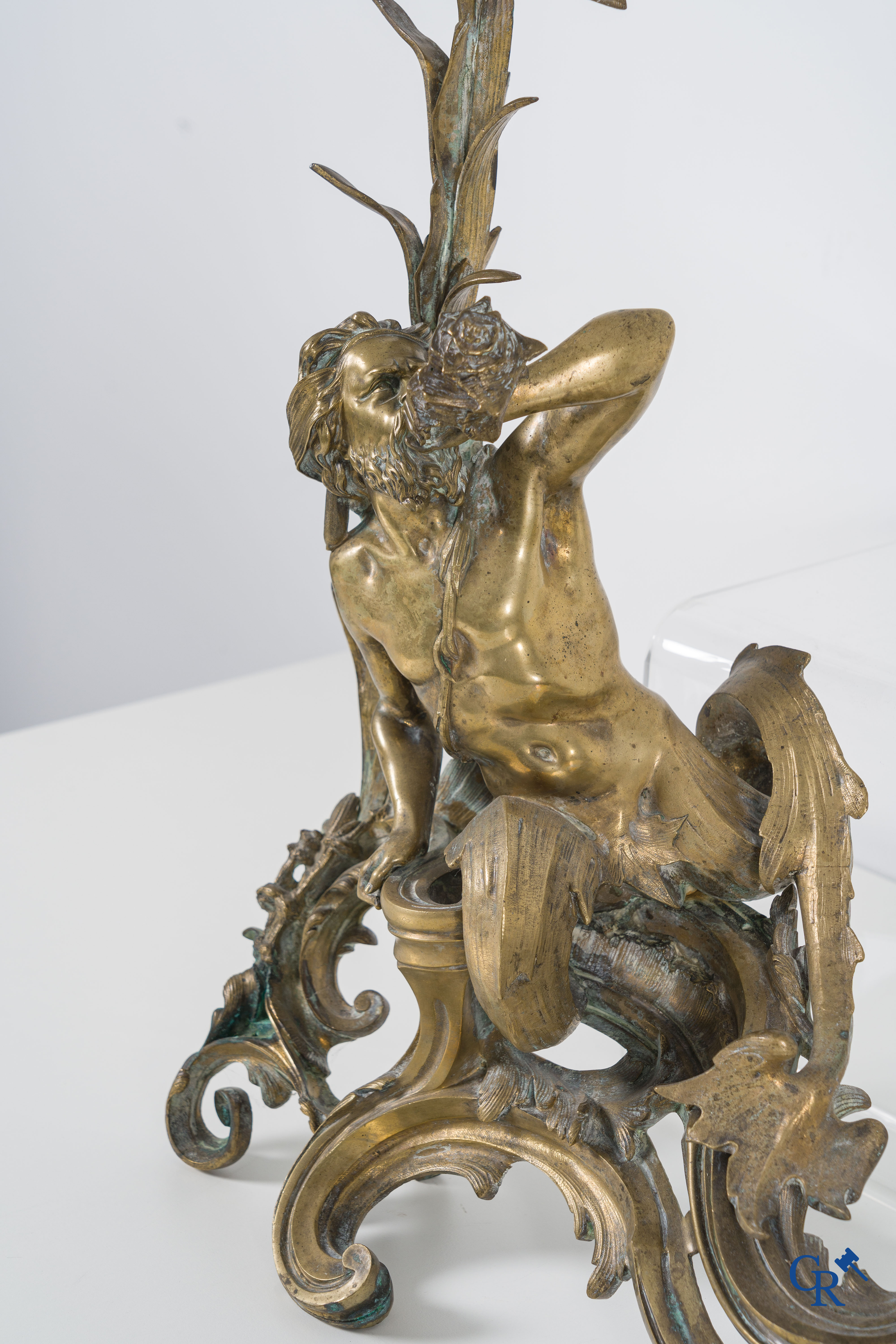 A large pair of finely chiseled bronze chenets with Tritons. Louis XV style. Napoleon III period.