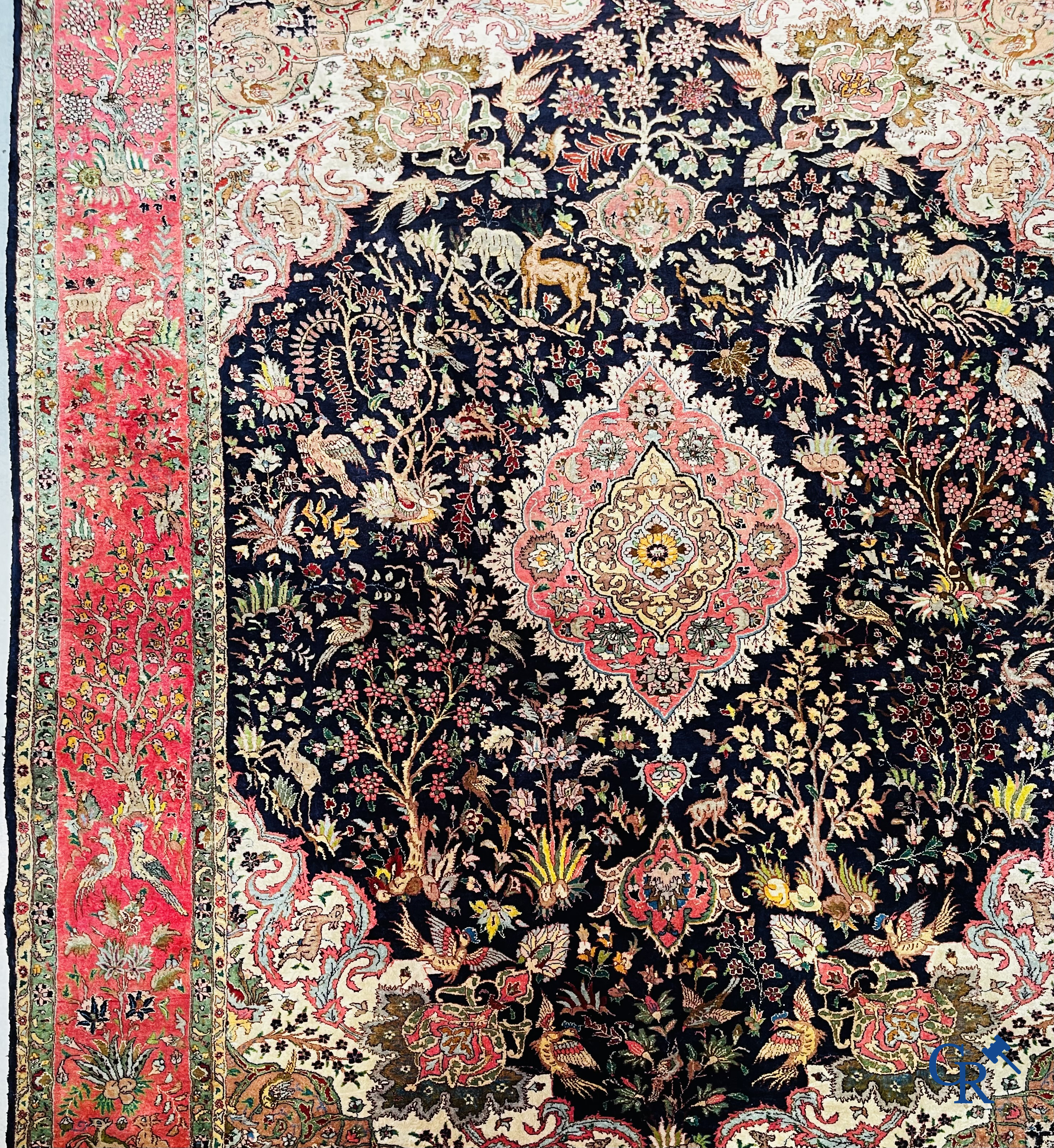 Oriental carpets: Tabriz, a finely hand-knotted silk carpet with forest animals and birds in a floral decor.