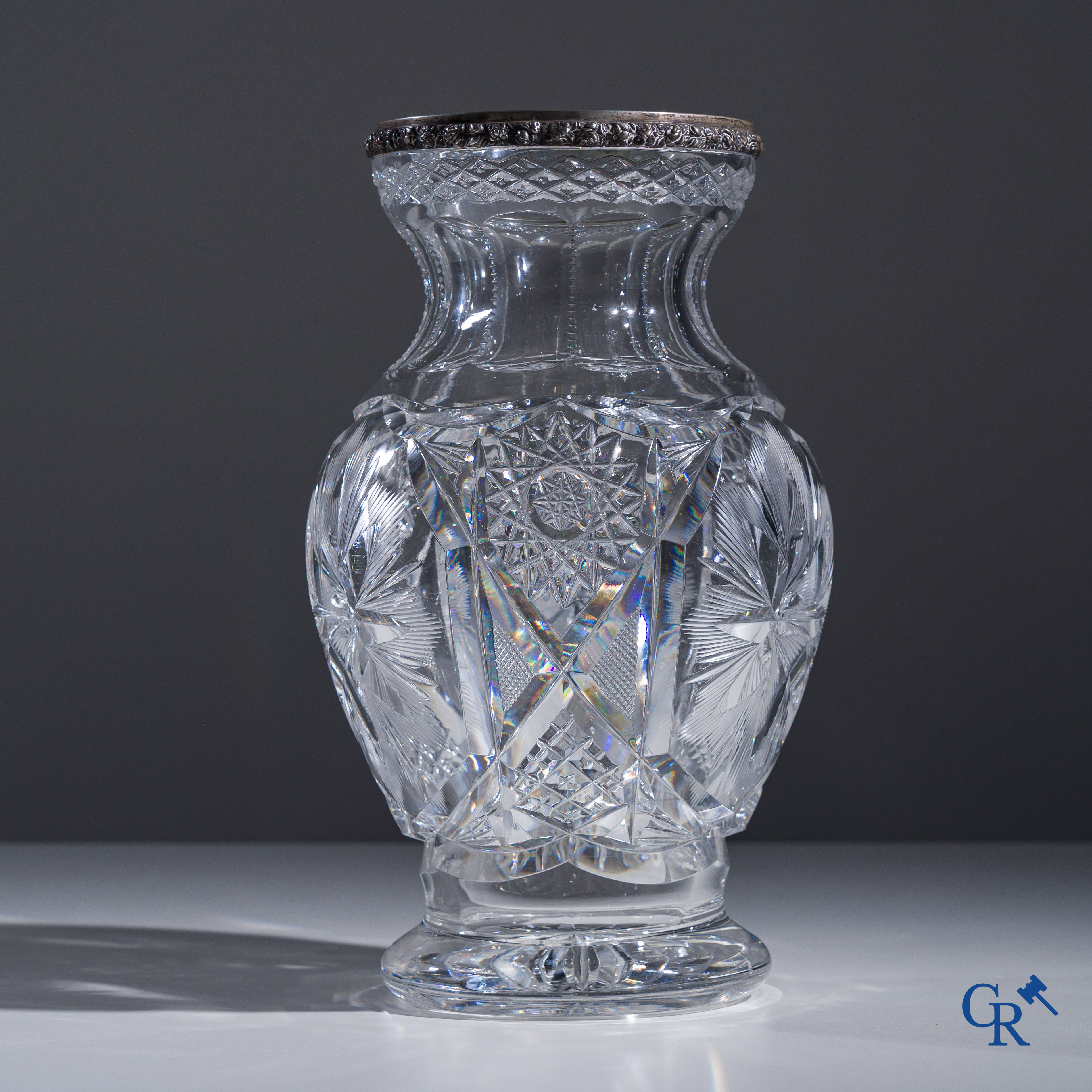 An imposing crystal vase with a silver frame.