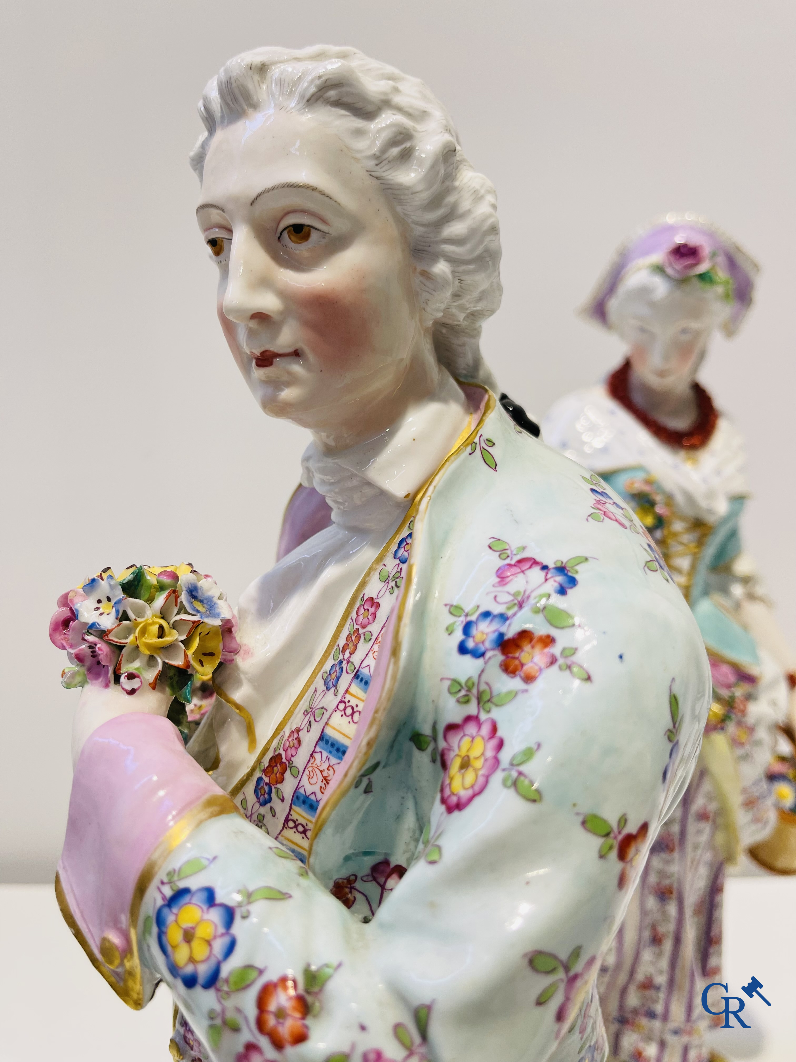 Exceptionally large pair of romantic statues in coloured and gilded porcelain in the manner of Meissen.