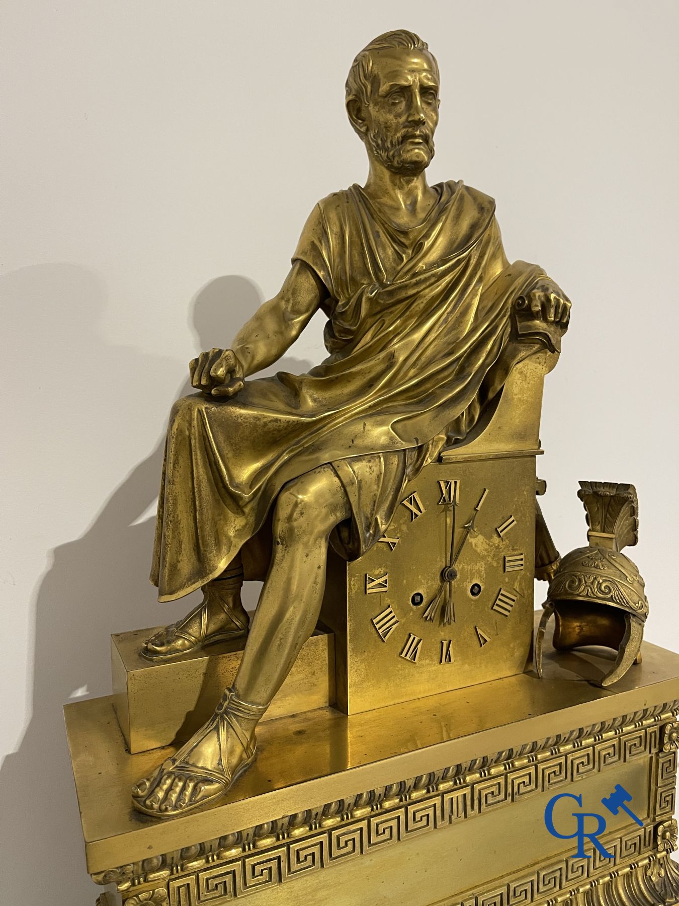 Imposing fire-gilded empire pendulum depicting a seated Roman emperor.