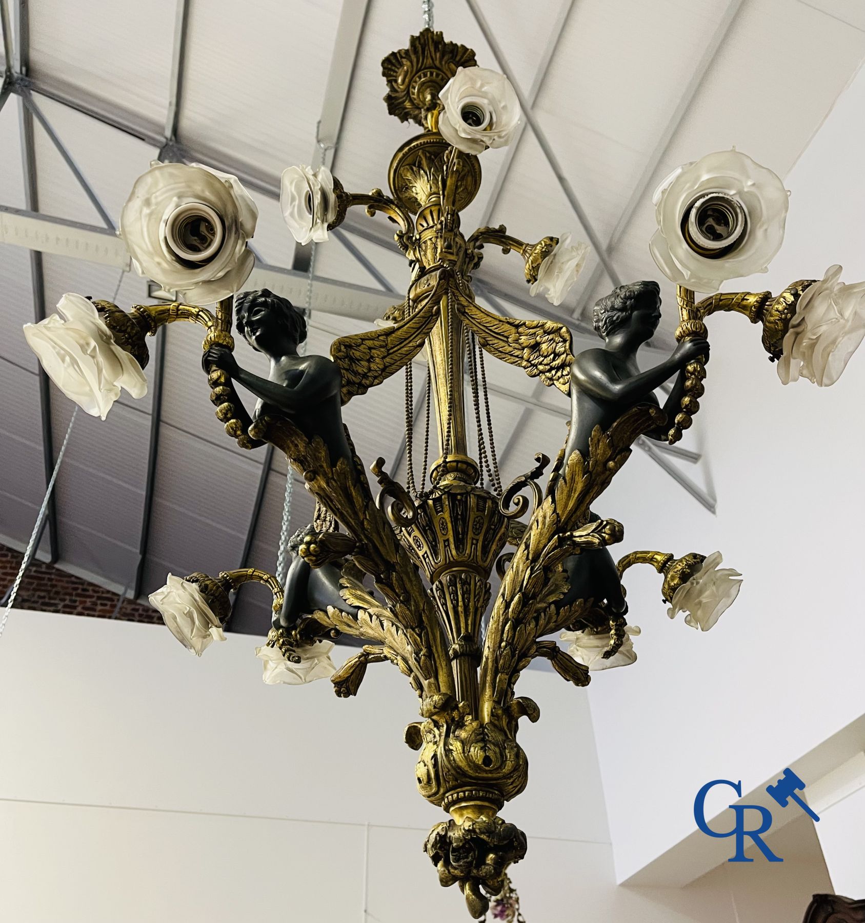 Chandelier: A large bronze chandelier in empire style. Period 1920.