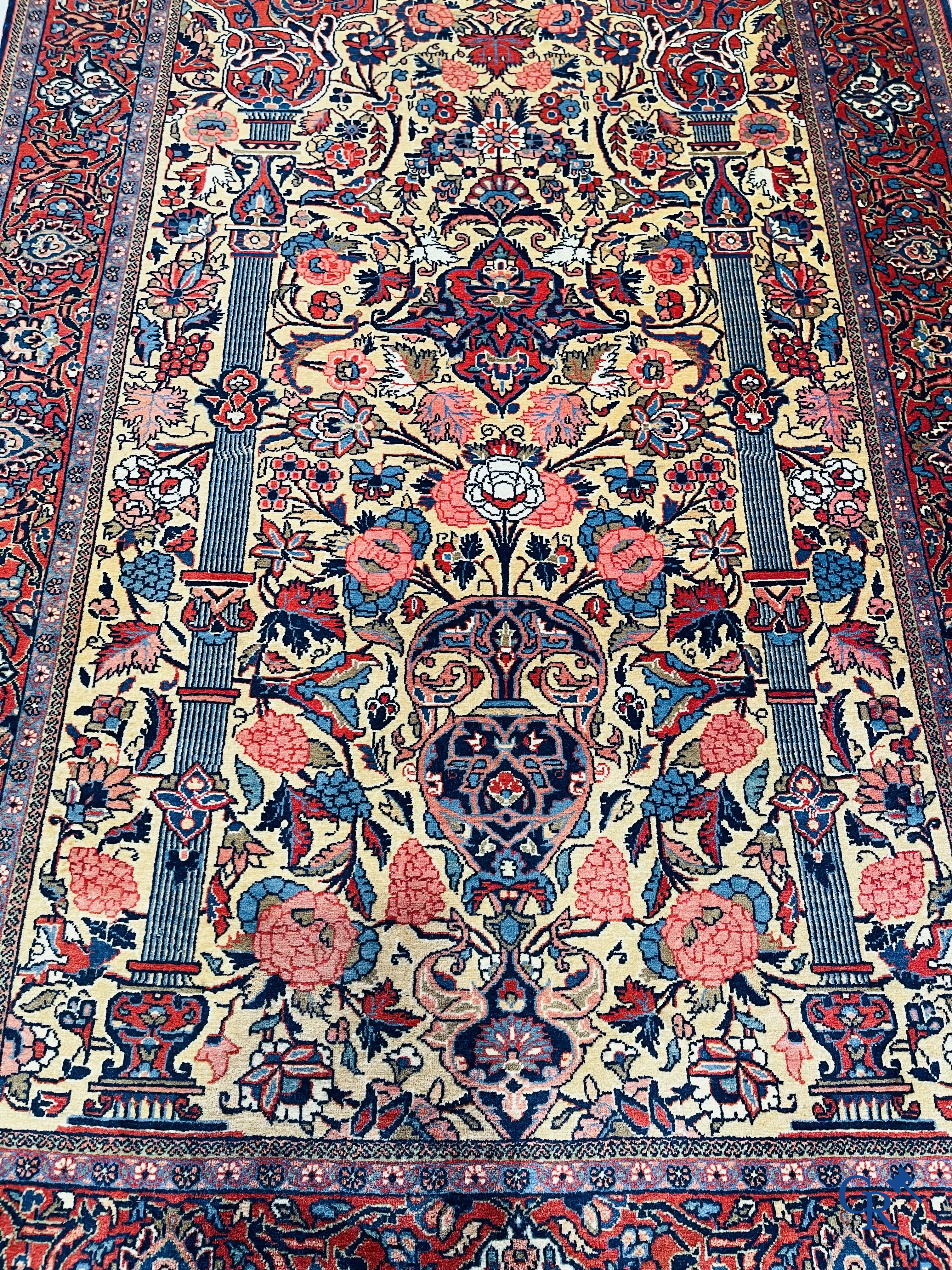 Oriental carpets: Iran. 2 antique hand-knotted Persian carpets with floral decor.