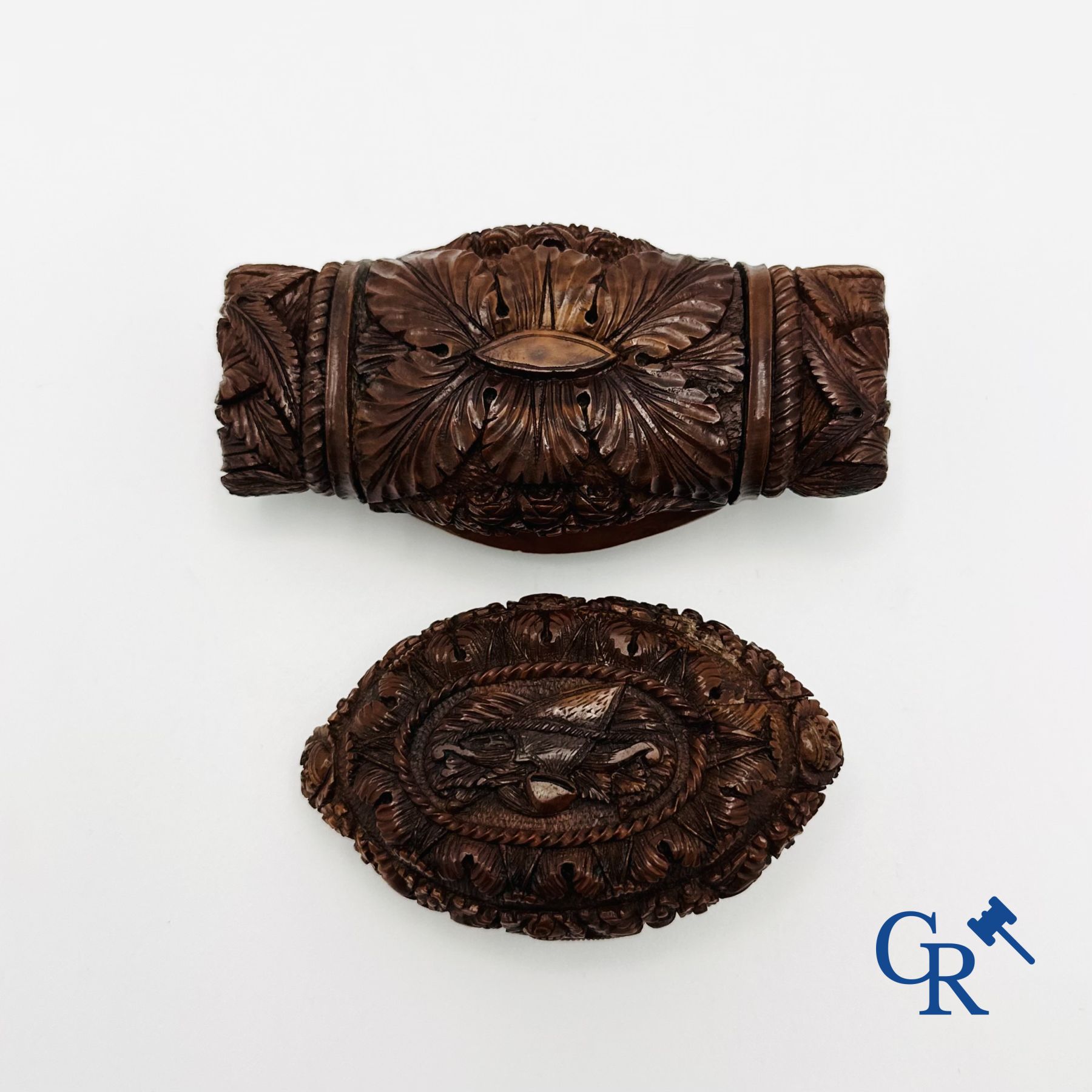 Display case objects: 2 pill boxes in sculpted corozo walnut.