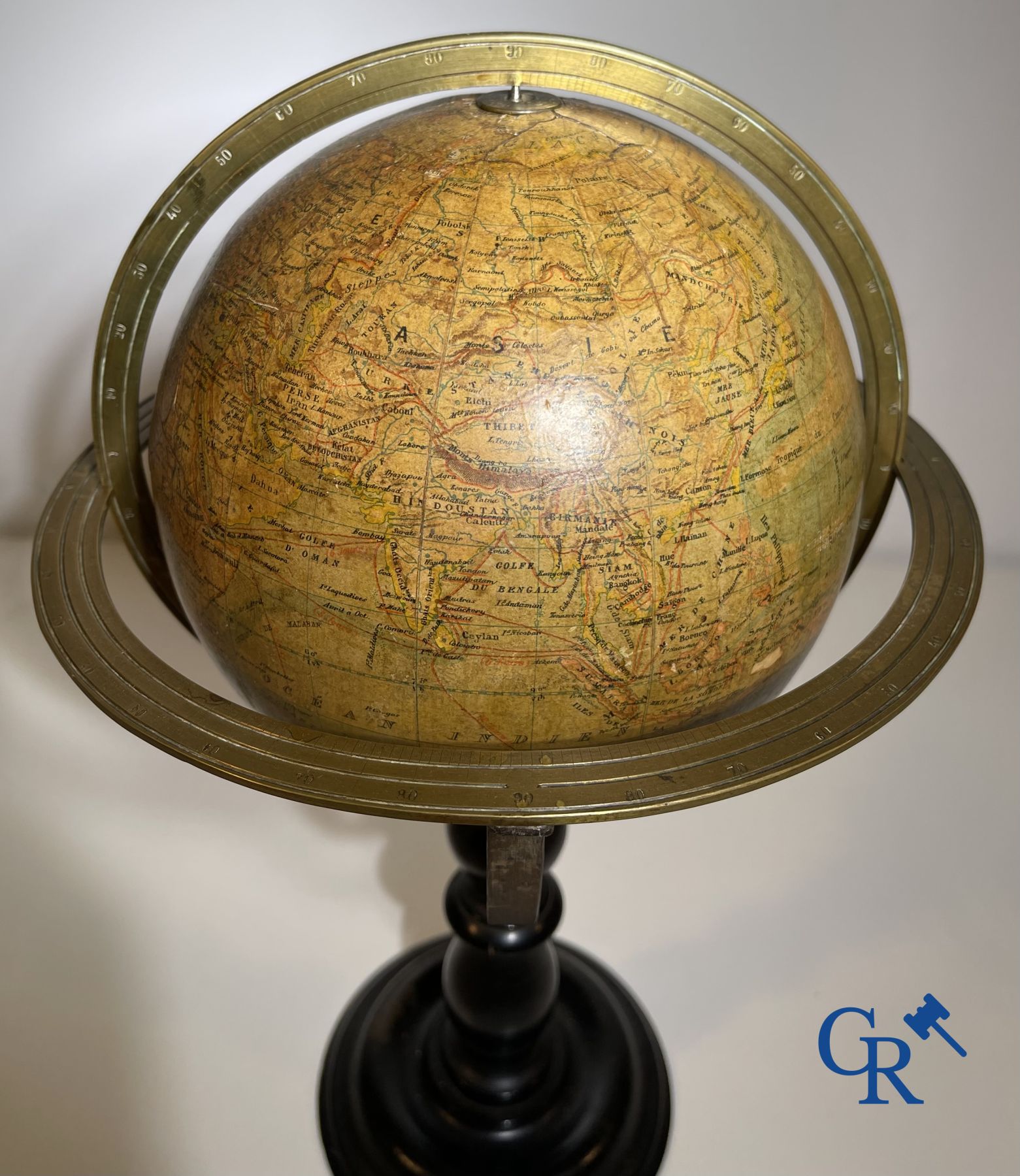 An antique globe with meridian circle on a black lacquered wooden base. 19th century.