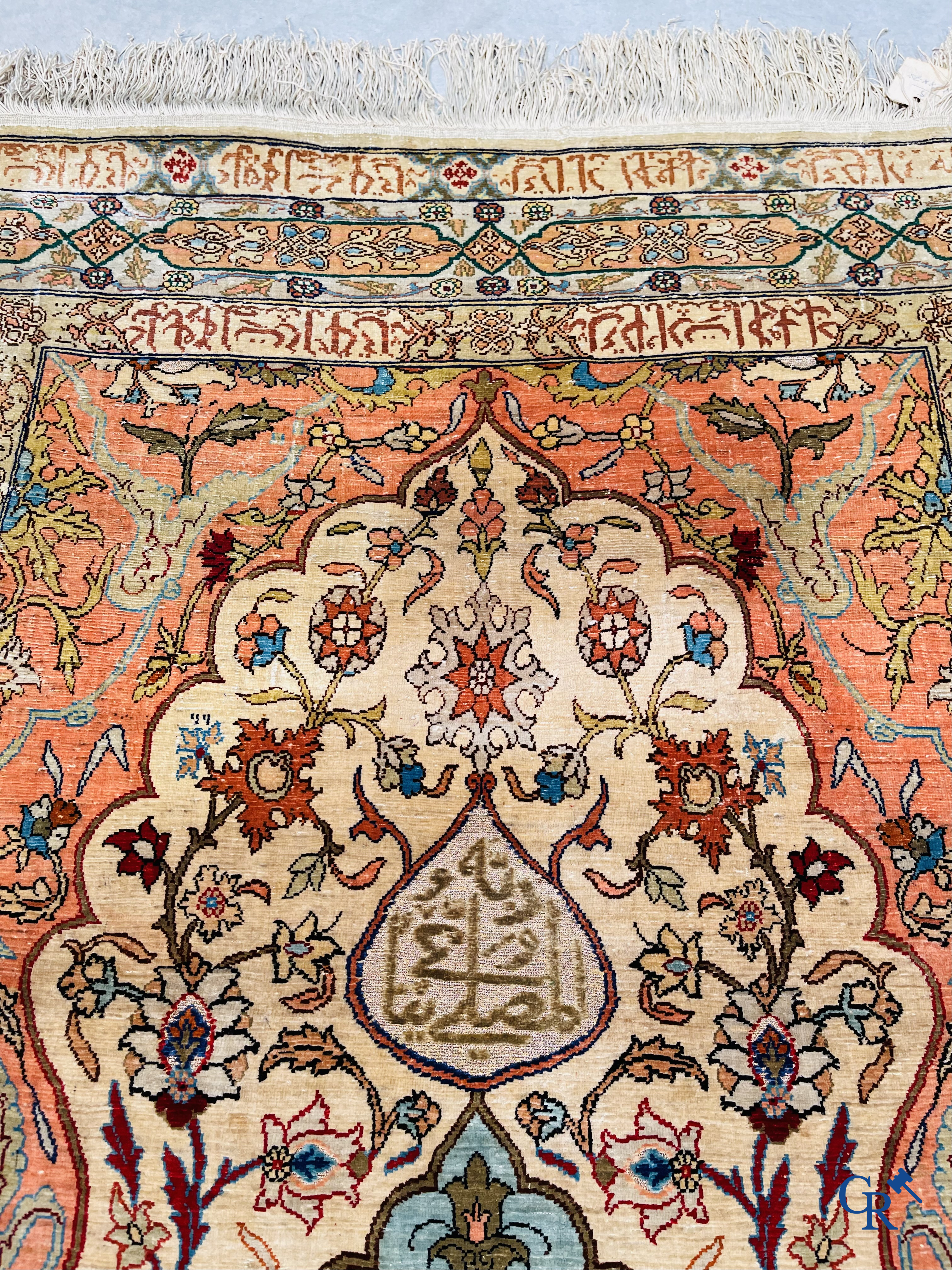 Oriental carpets, Hereke Turkey, a finely hand-knotted silk carpet with inscriptions and gold thread.