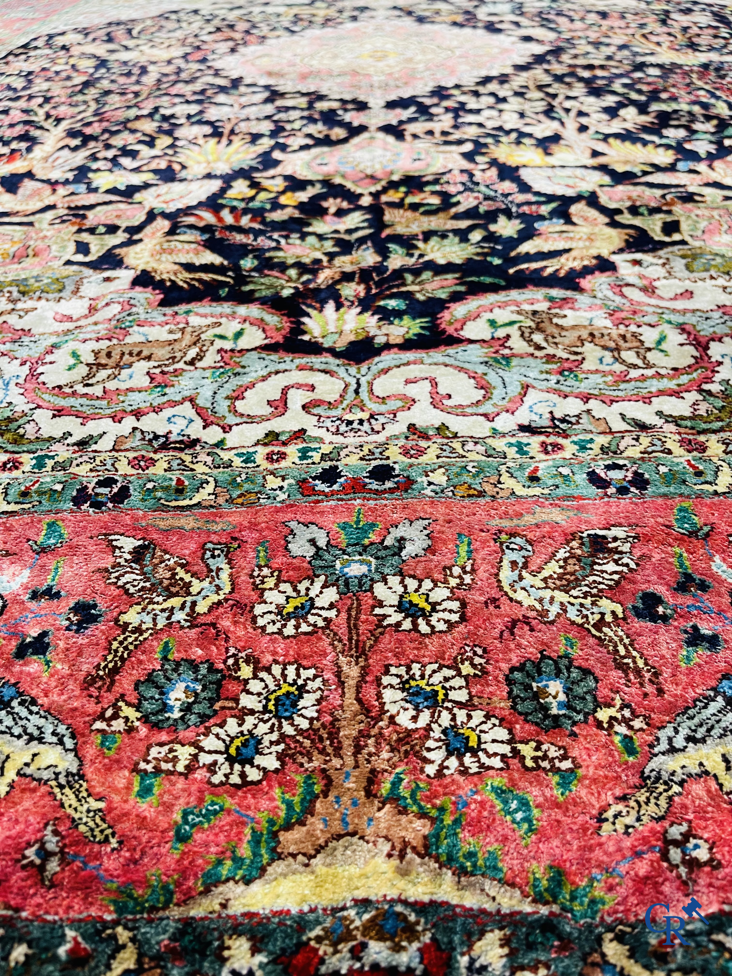 Oriental carpets: Tabriz, a finely hand-knotted silk carpet with forest animals and birds in a floral decor.