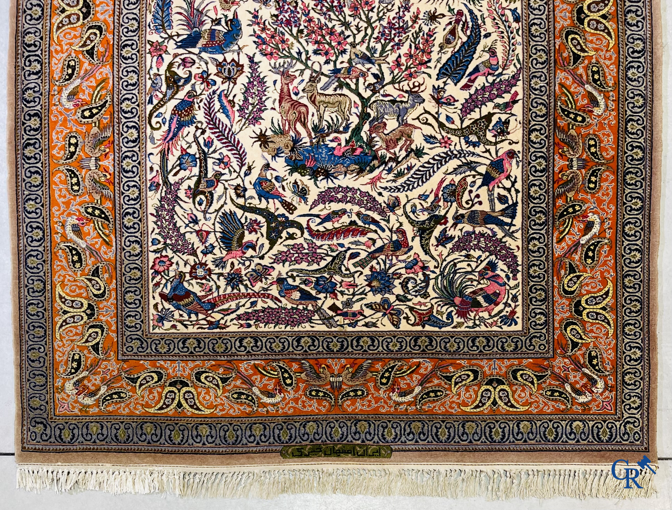 Oriental carpets, a finely hand-knotted silk carpet with forest animals. Signed.