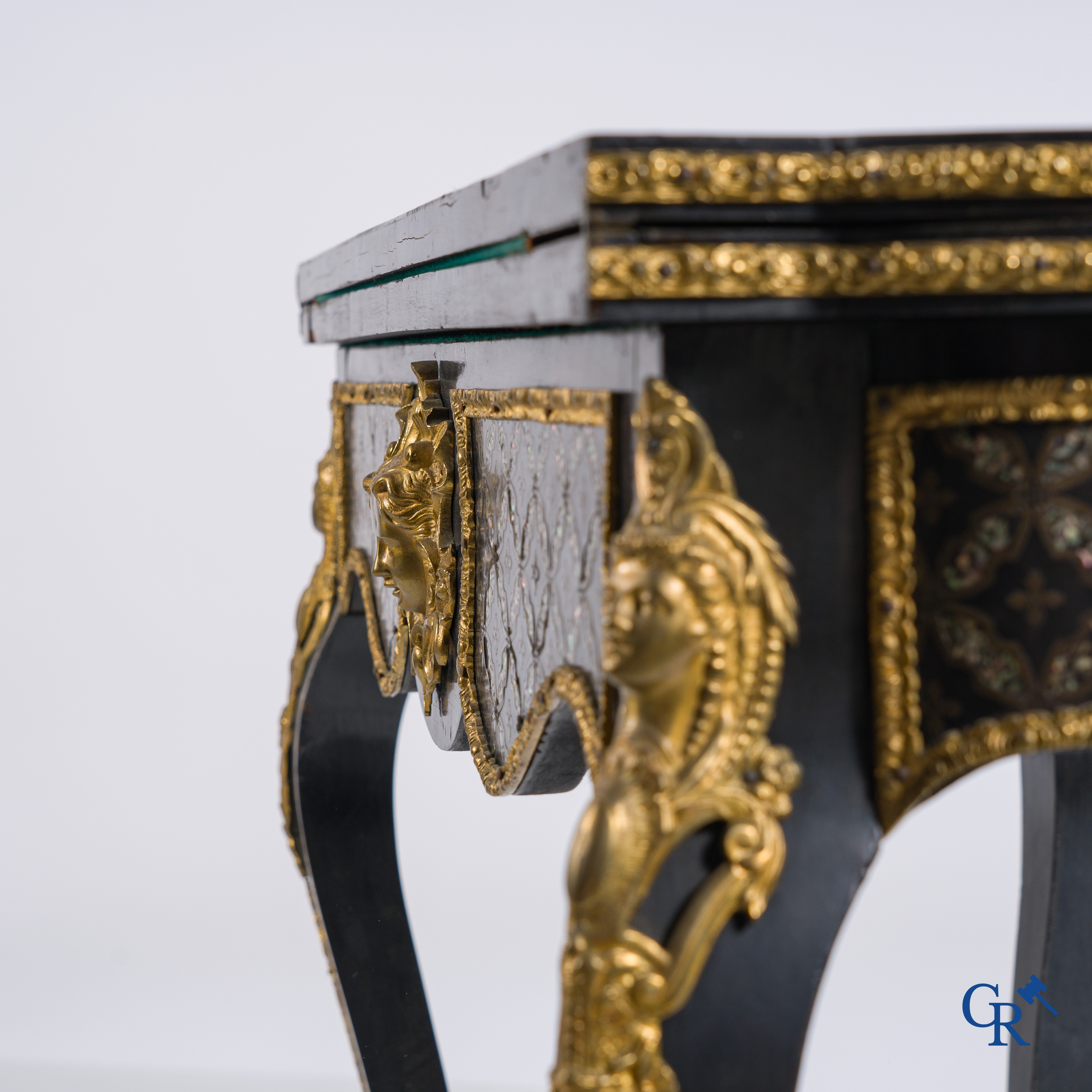 A card table with finely gilded bronze ornaments and inlay of copper and mother-of-pearl, circa 1880.