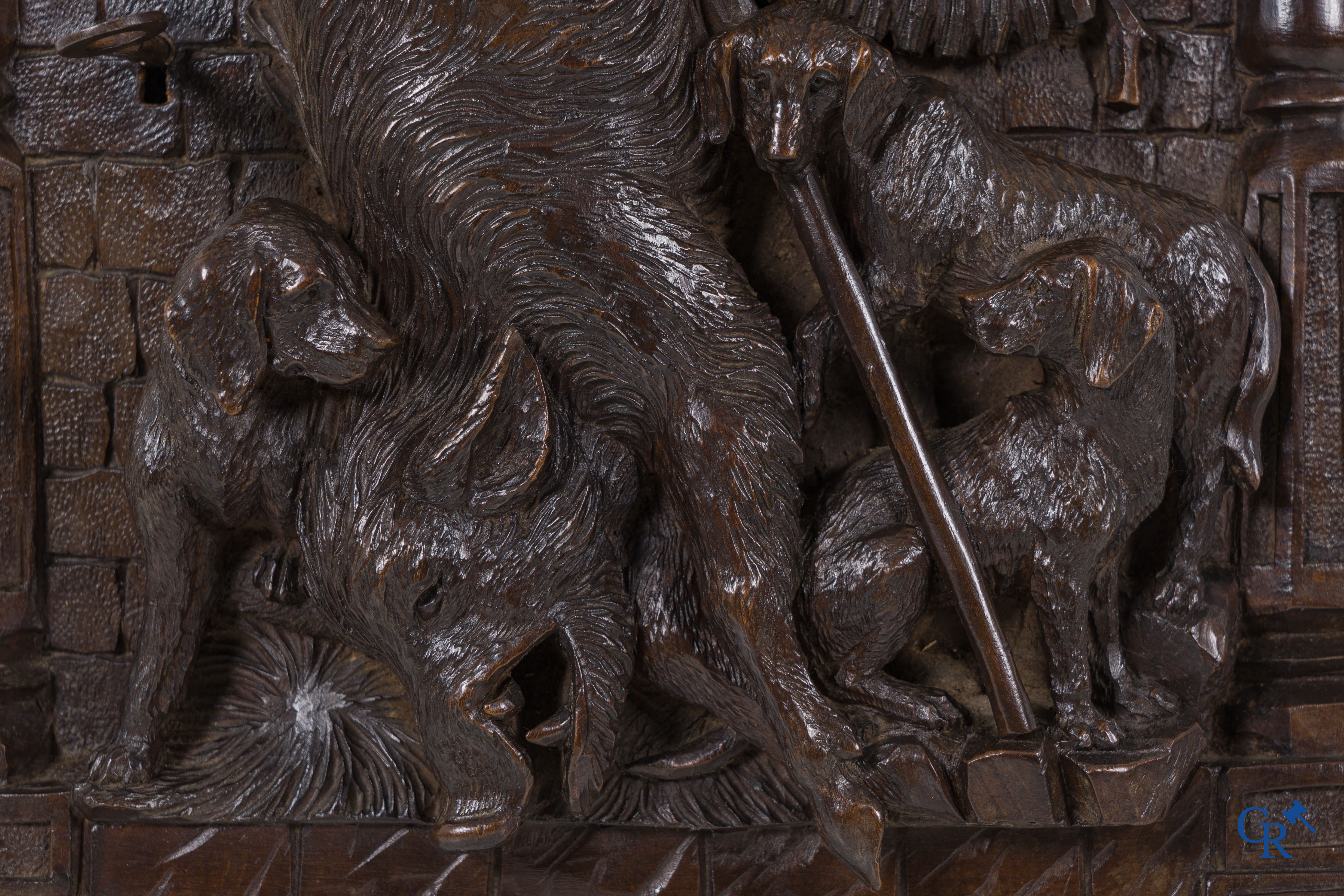 Black forest carvings. Key cabinet in richly sculpted wood with hunting scenes. Circa 1880.