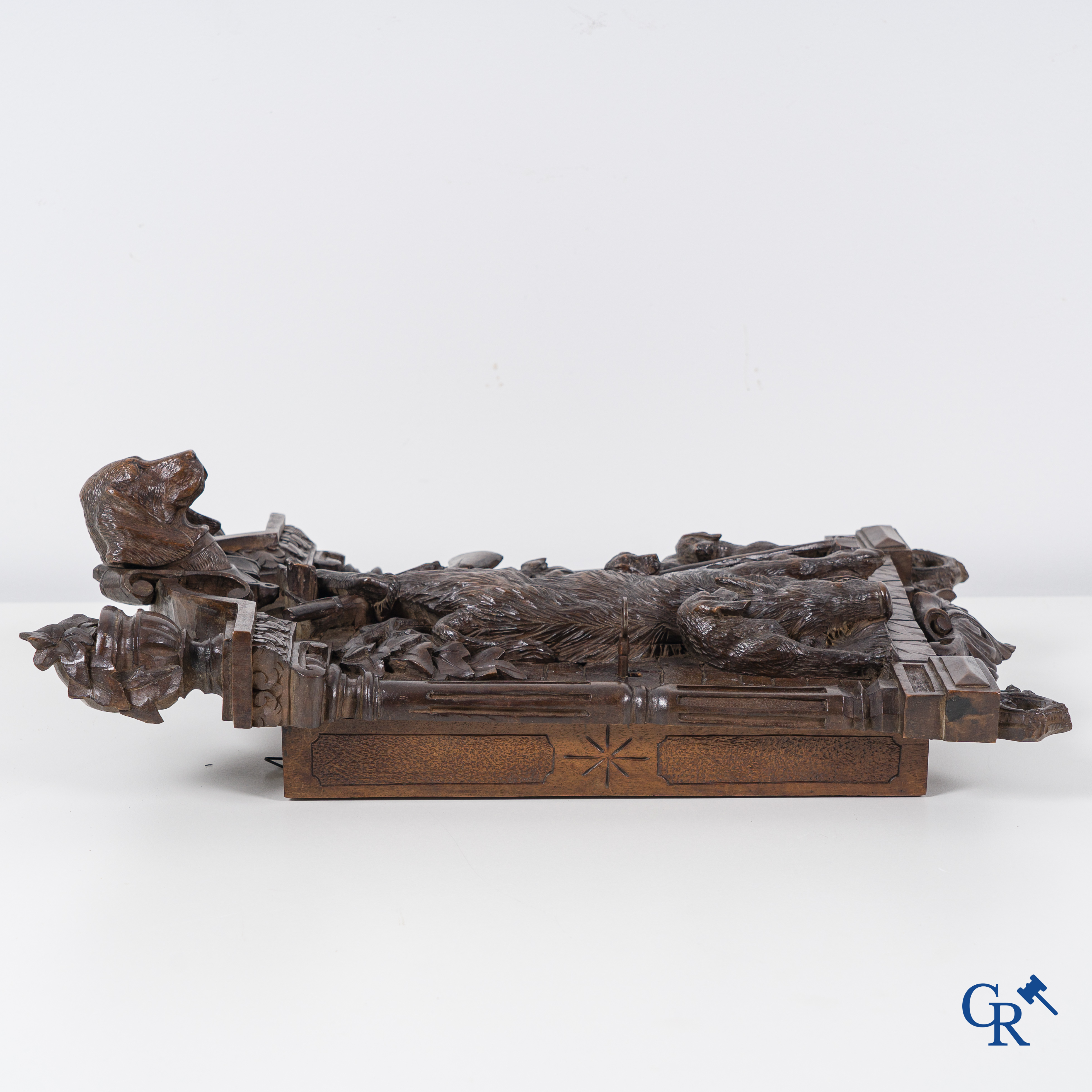 Black forest carvings. Key cabinet in richly sculpted wood with hunting scenes. Circa 1880.